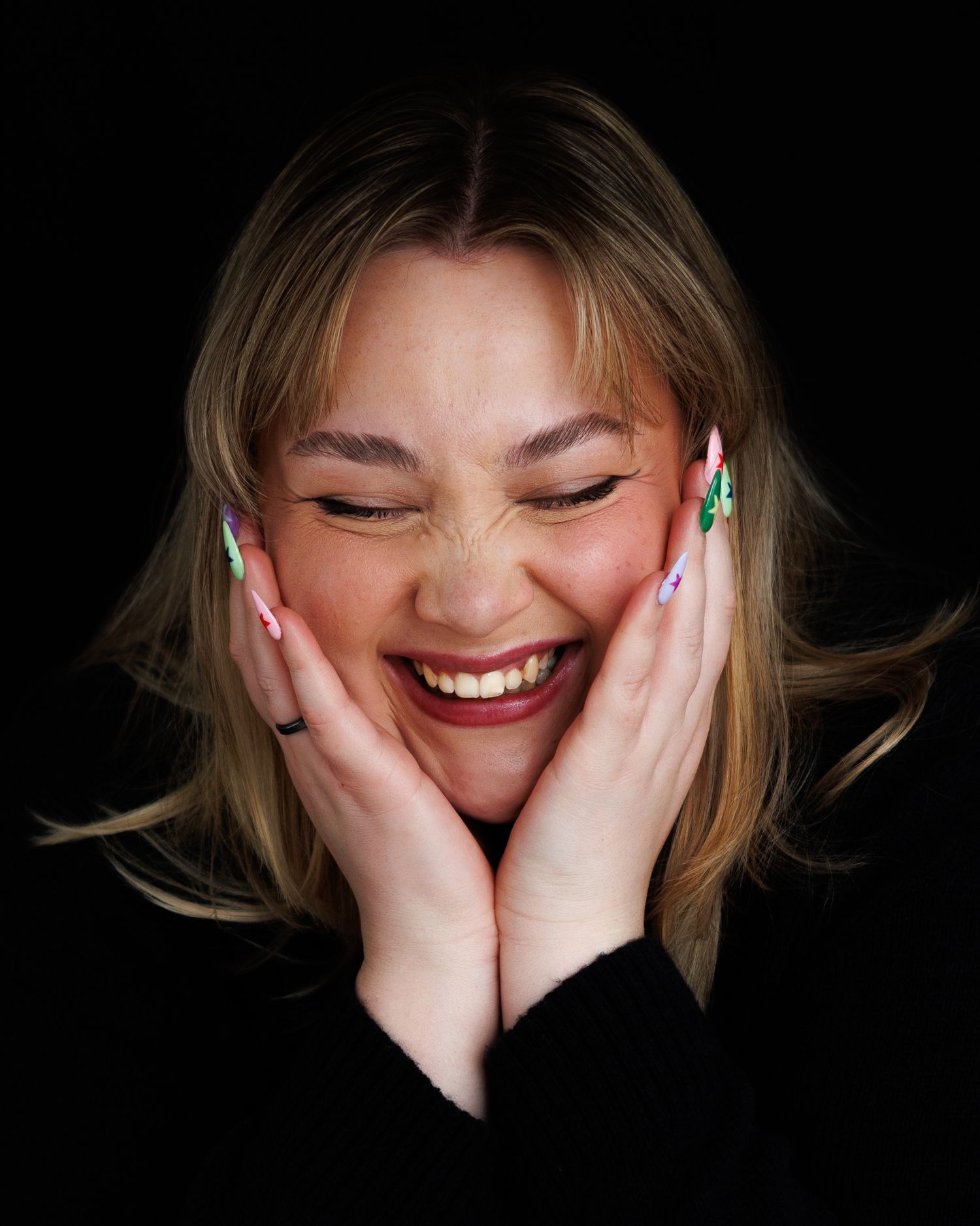 A sequence of photos showing a person covering their face with hands while laughing against a black background.