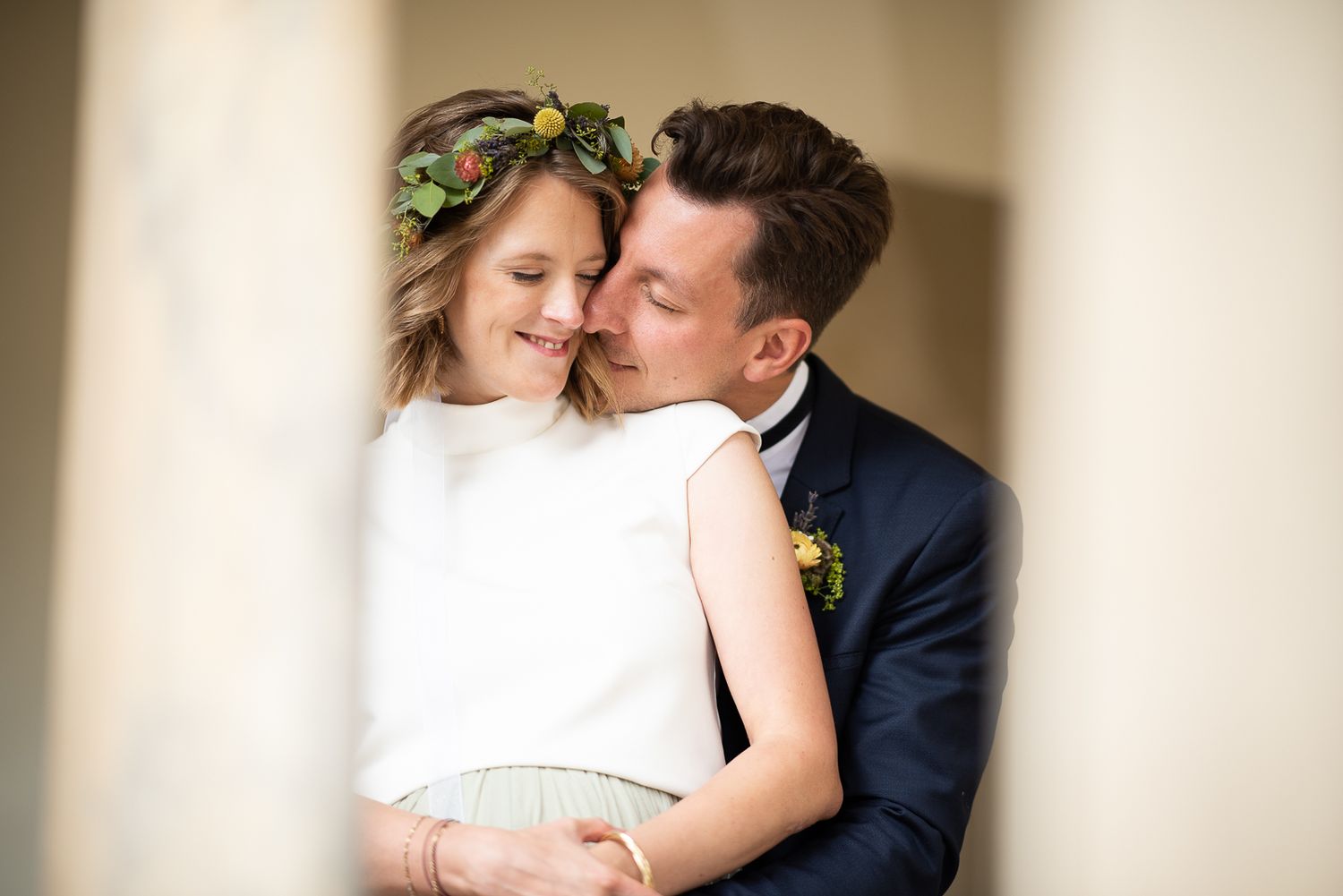 Romantic wedding couple shares intimate moments in a soft-lit hallway setting.
