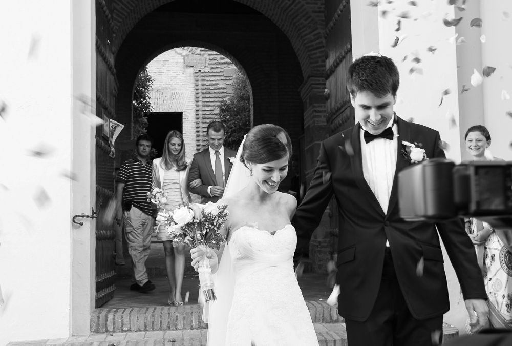 A black and white photo collage showing multiple wedding moments with couples embracing and celebrating.