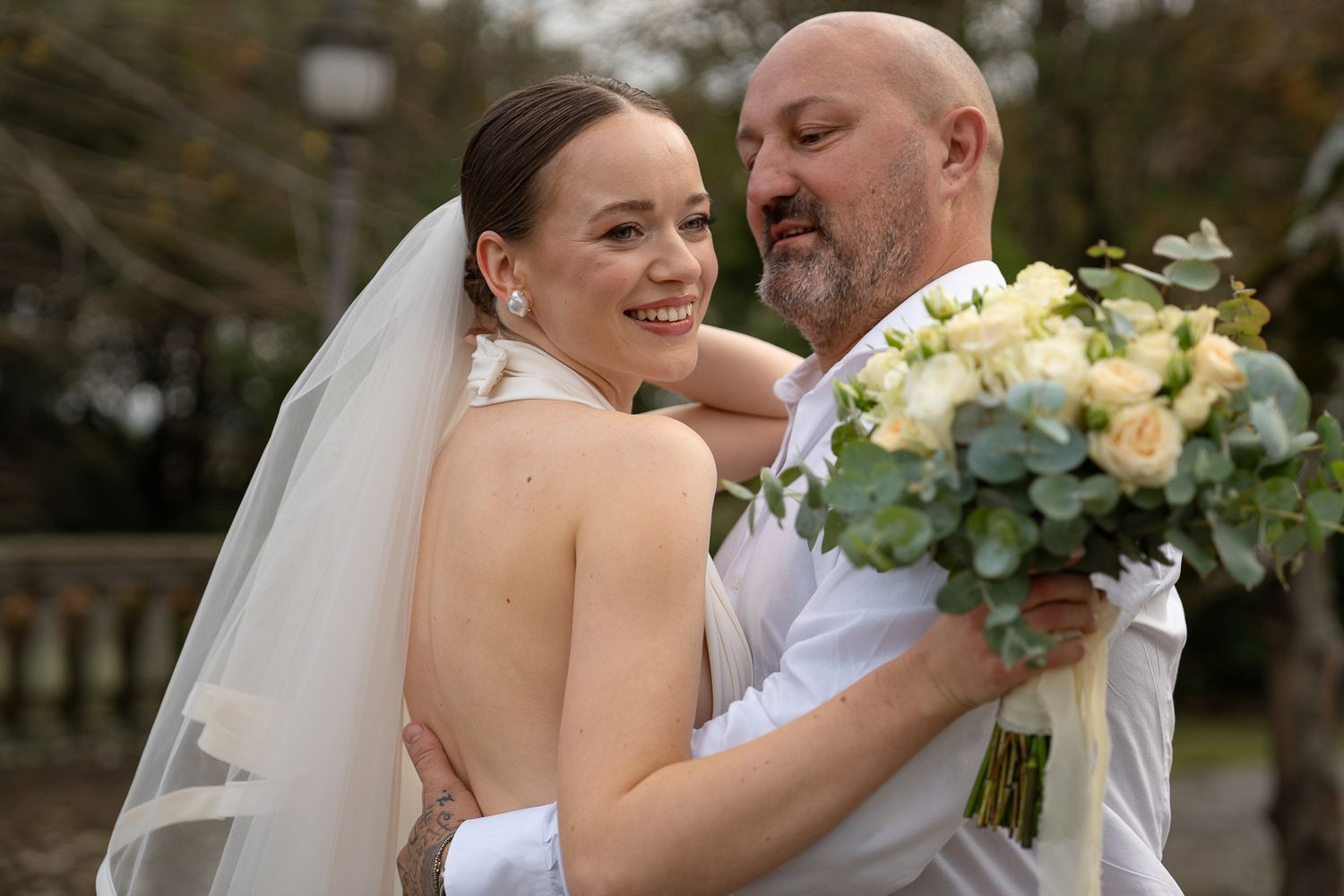 A joyful wedding couple embraces and shares intimate moments during their outdoor intimate wedding celebration in Italy.