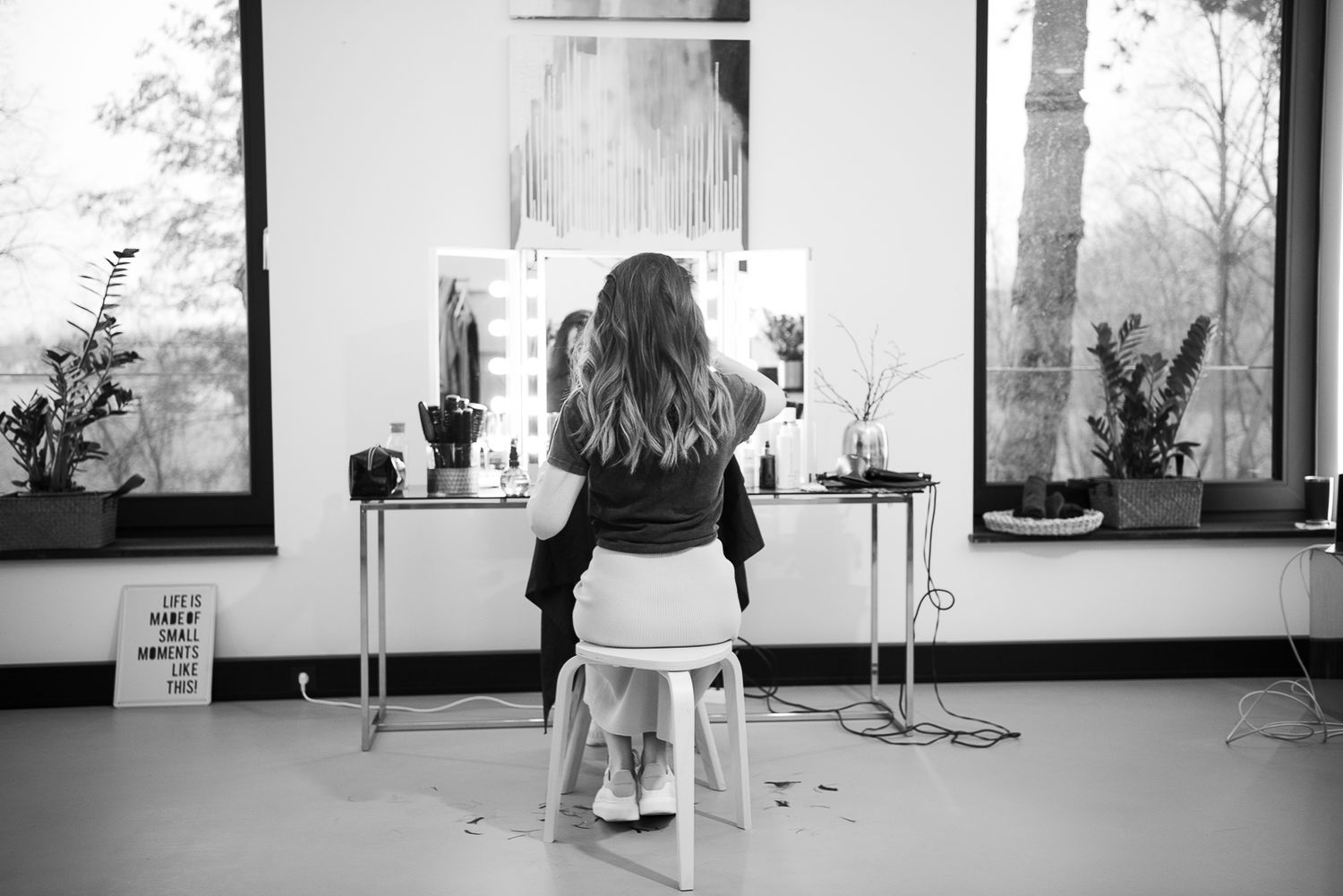A black and white photo series shows a person sitting on a chair in various positions against a window backdrop.