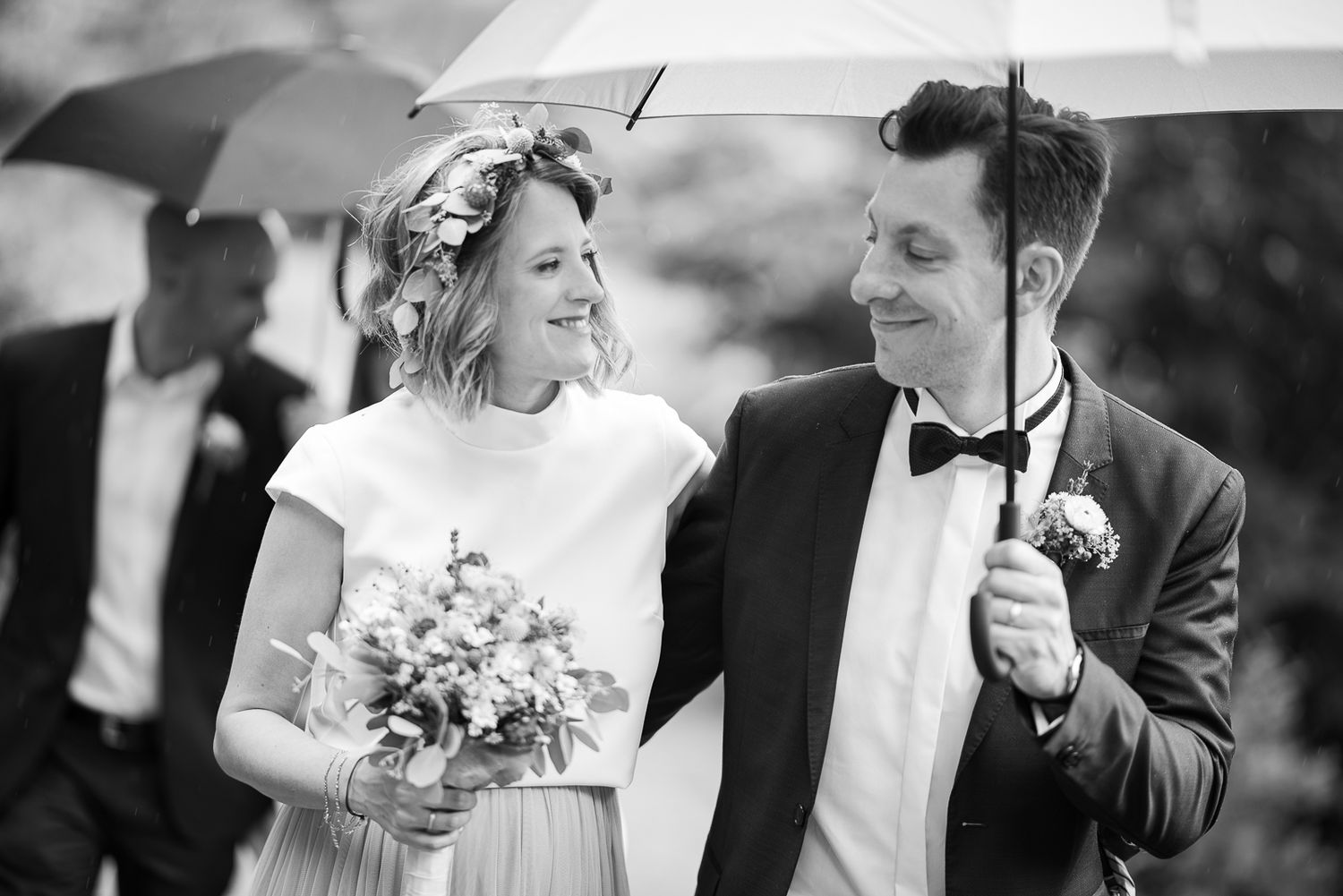 A collection of black and white wedding photographs showing joyful moments between couples during their special day.