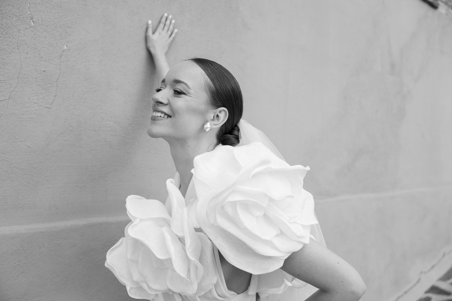 A black and white photo sequence shows a person in white performing expressive dance movements against a light background.