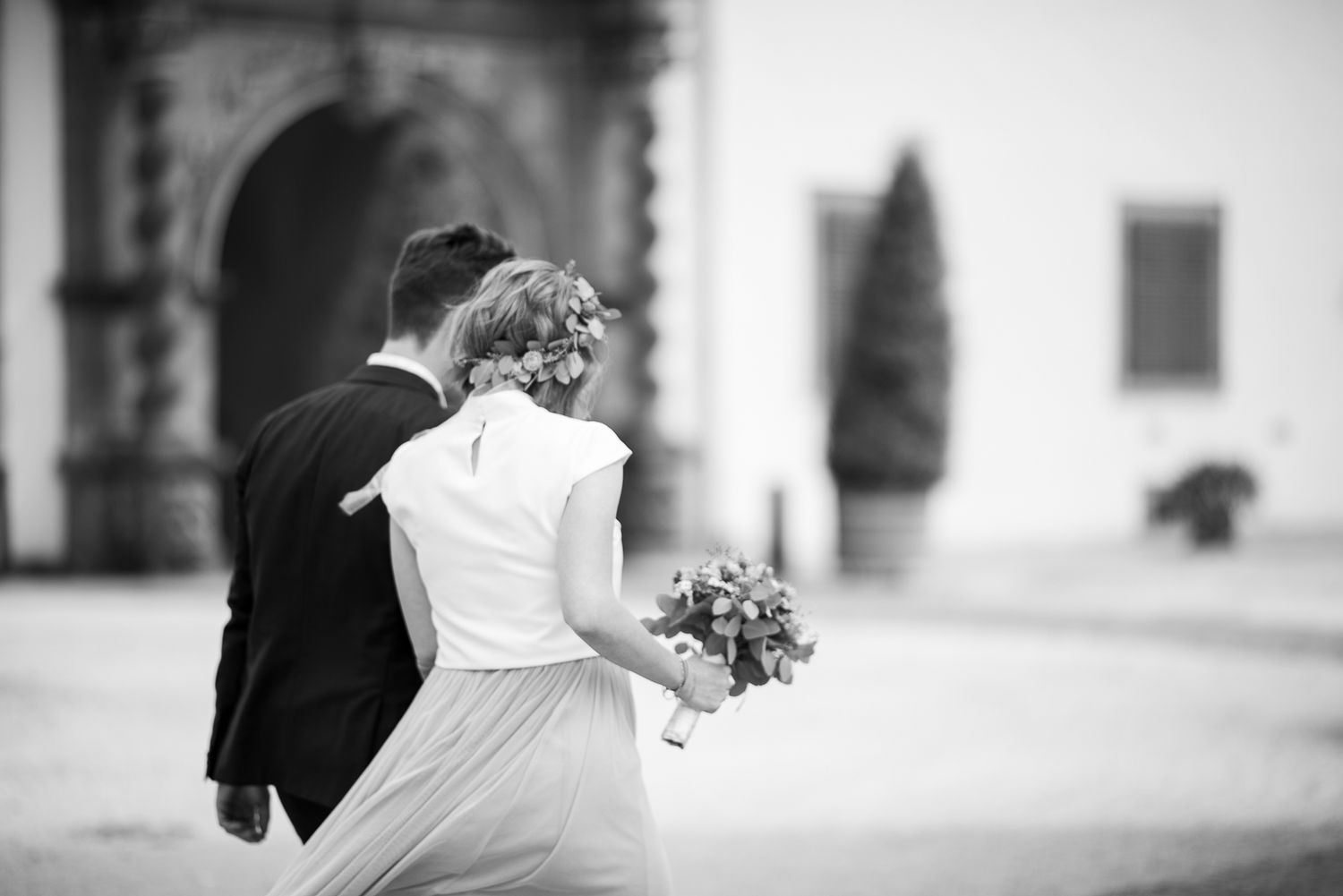 A black and white wedding photo collage showing intimate moments and embraces between the newlyweds.