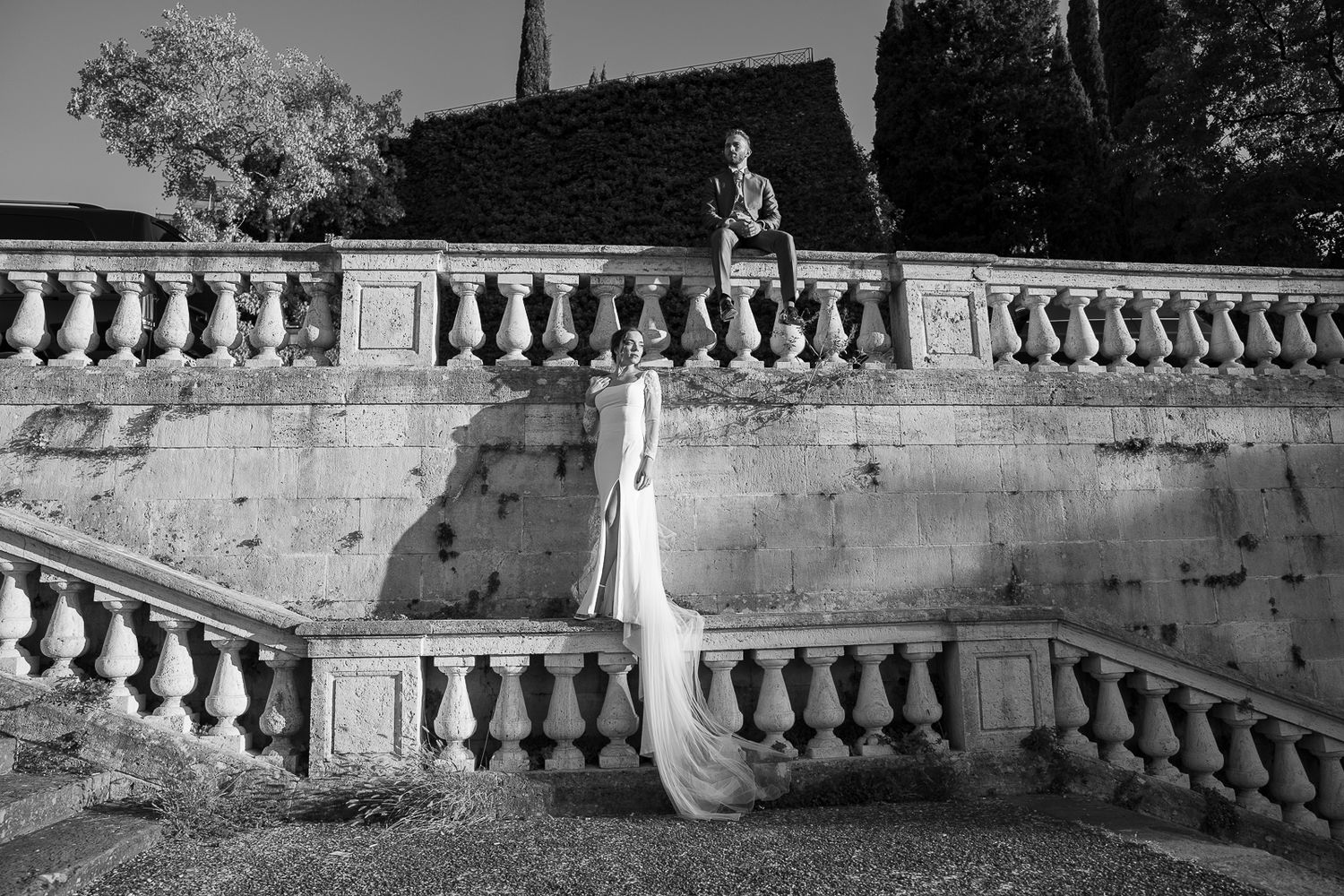 A black and white architectural detail showing an ornate stone balustrade with decorative balusters and railing.