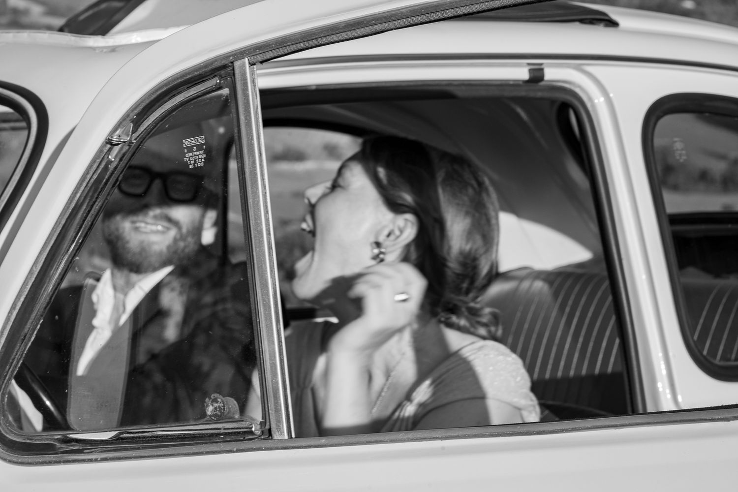 Classic black and white photo showing interior of vintage automobile.