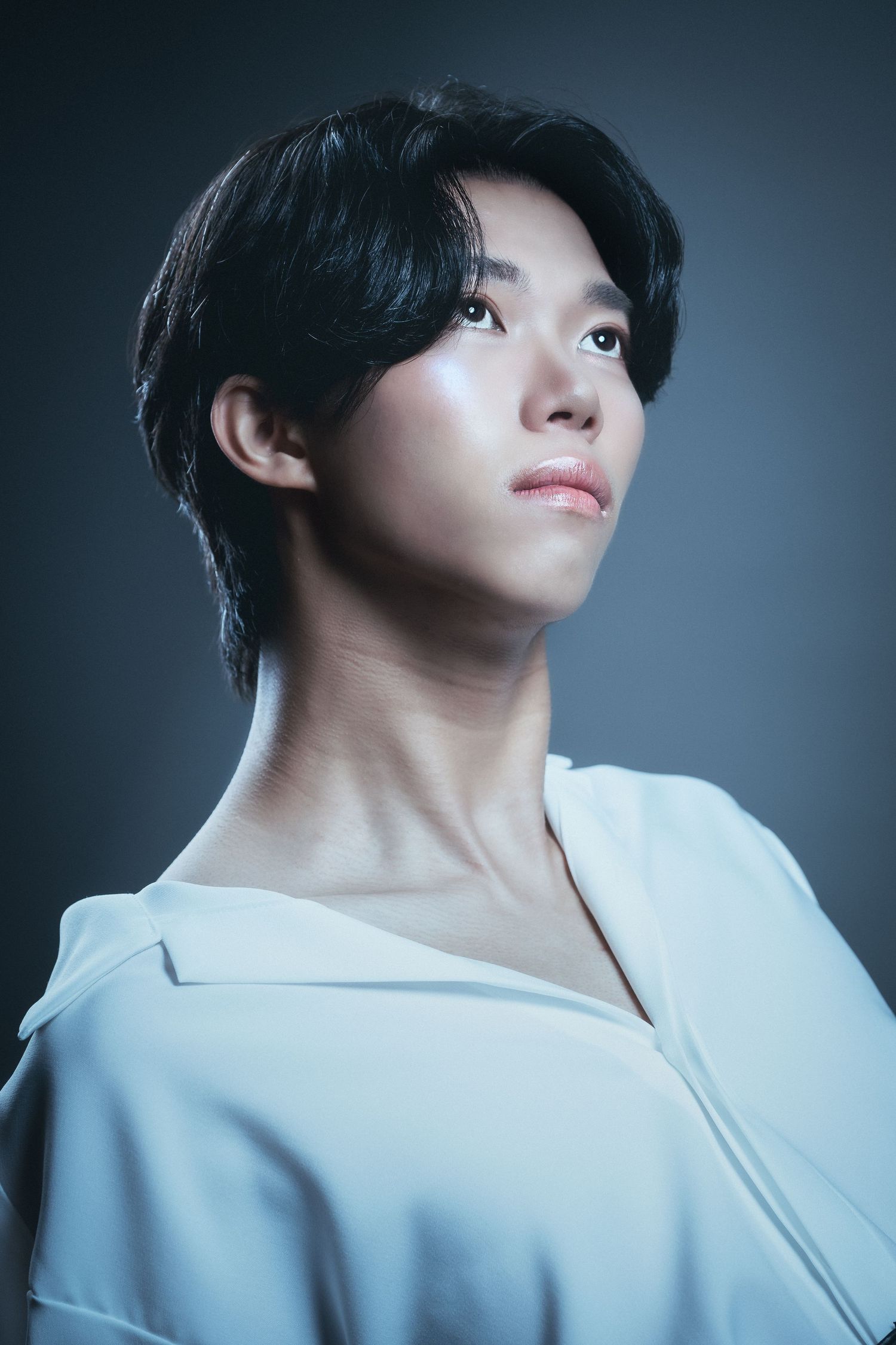Minimalist fashion portraits in white clothing with artistic angles and lighting.