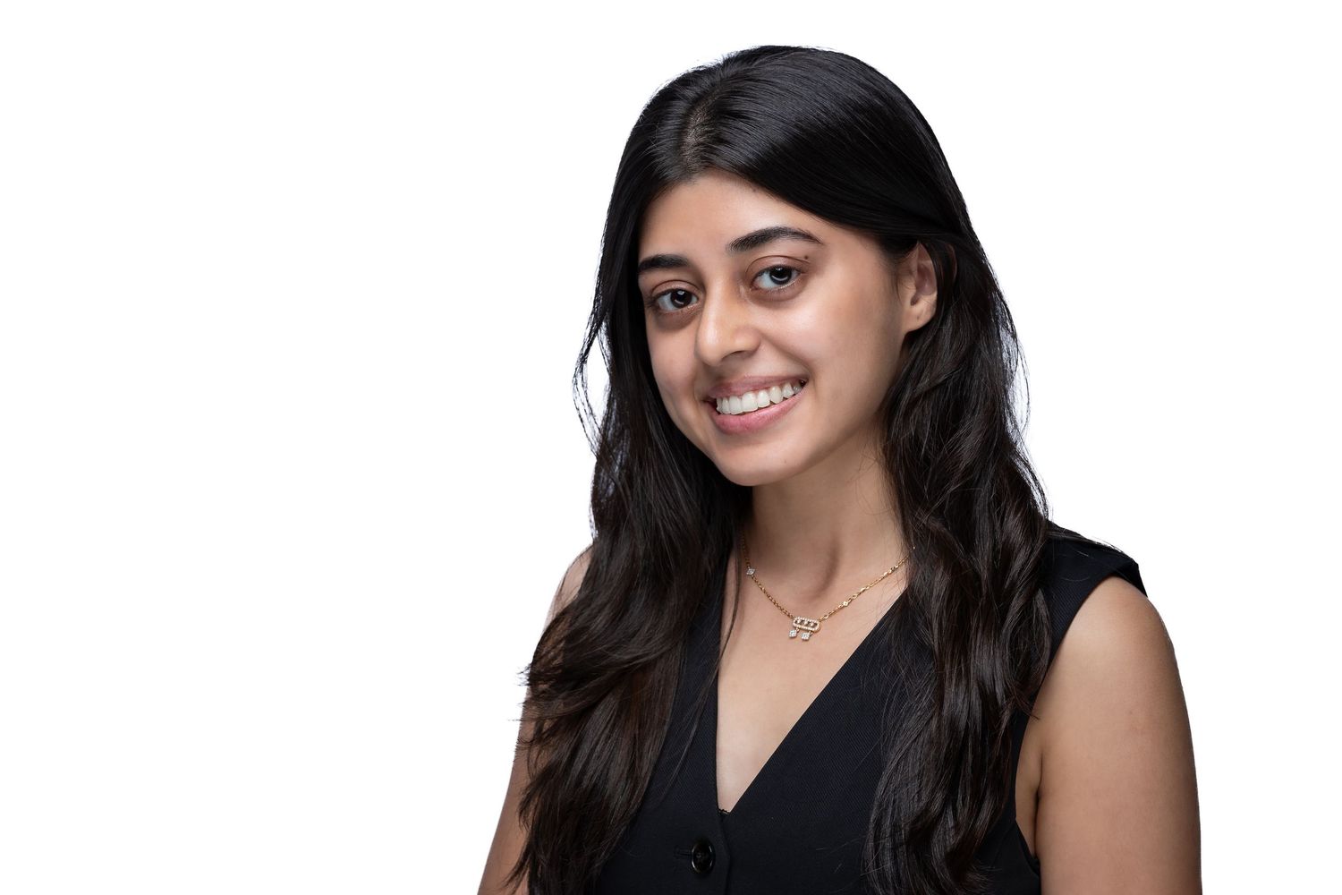 A person with long dark hair wearing a black sleeveless top smiles in a professional headshot photo series.