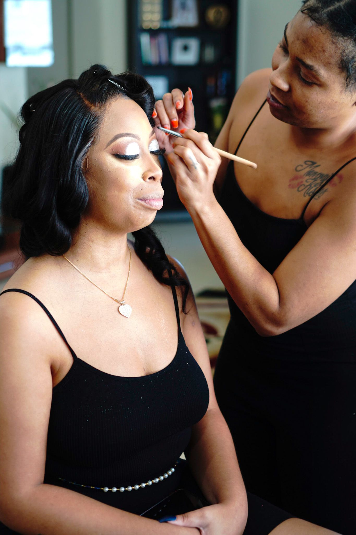 Professional makeup application in progress showing detailed cosmetic artistry.