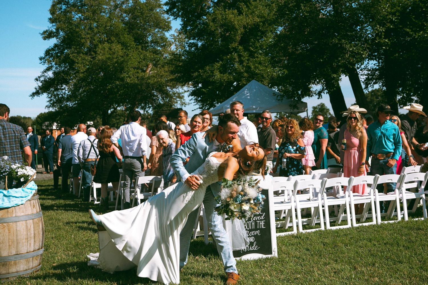 Groom dips his bride after walking down the aisle during Walla Walla Wedding ceremony, Pacific Northwest photography cinematic moment
