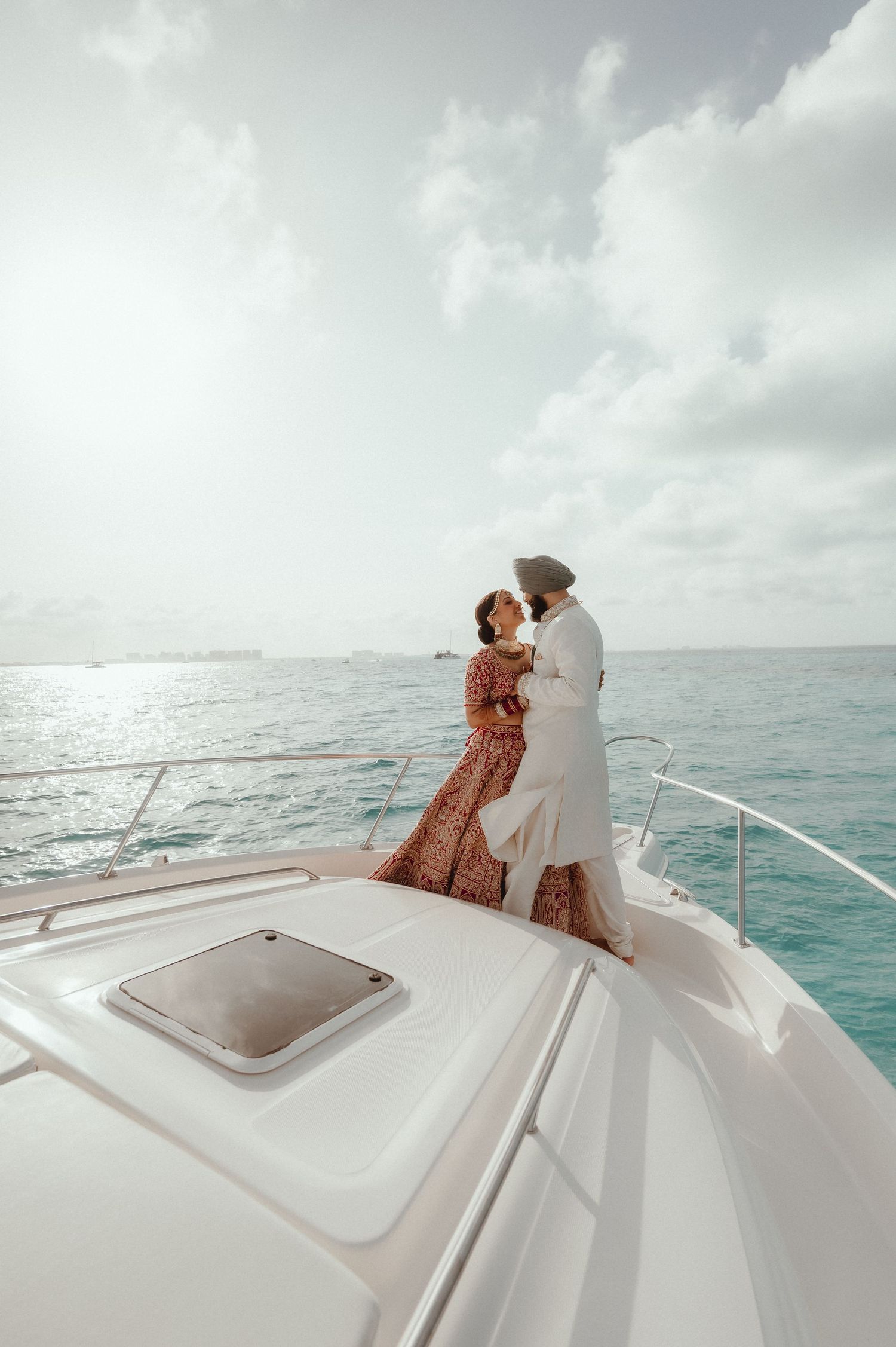 Romantic couple moment on a luxury yacht sailing in turquoise waters.