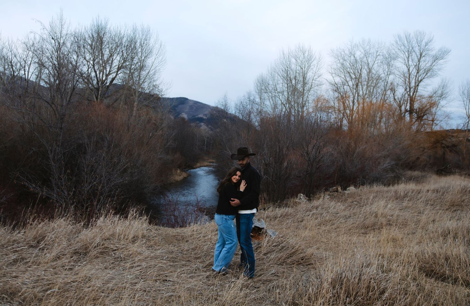 Couple in Montana with cowboy hats and cowboy boots.
