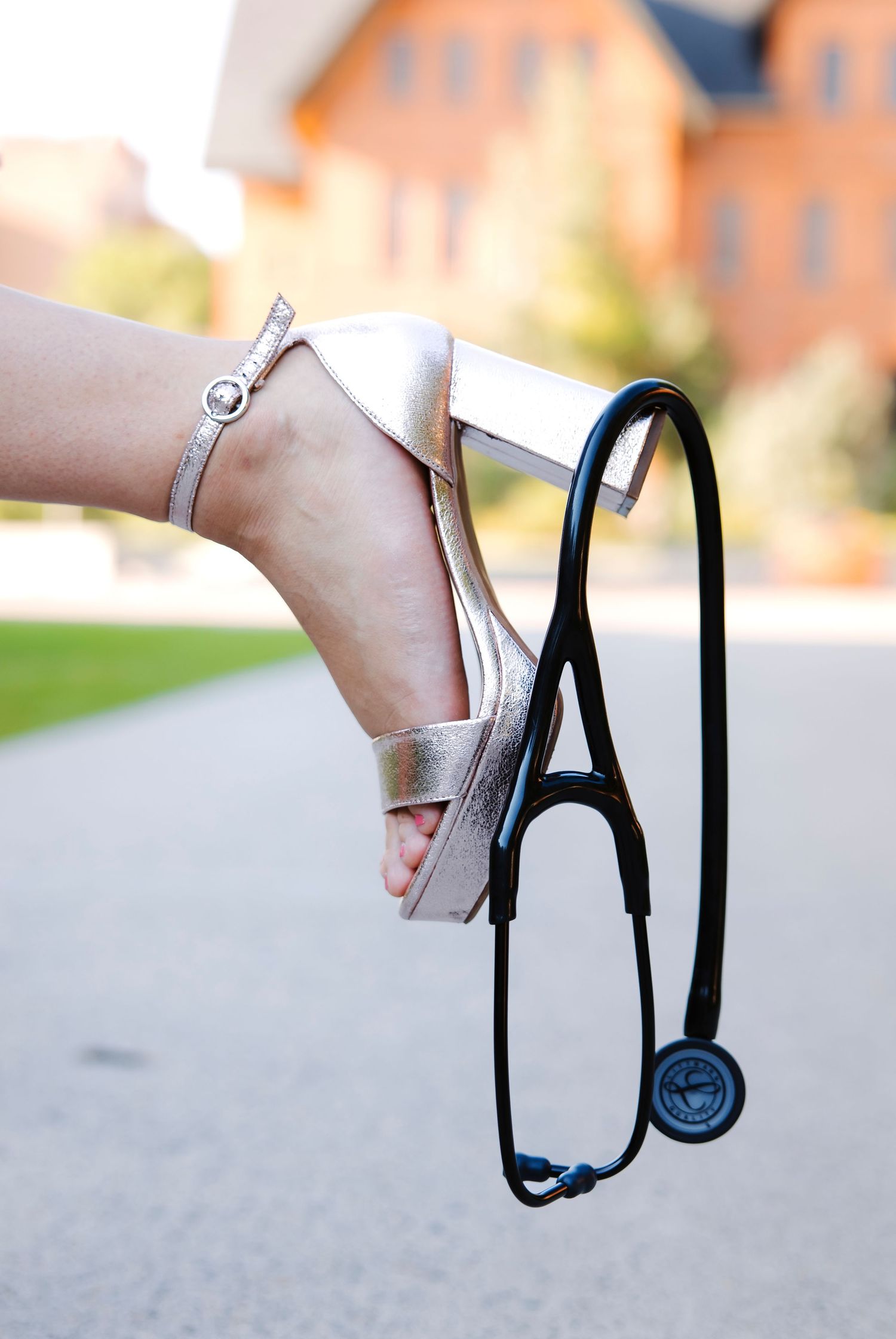 Close-up of hands holding medical stethoscope against blurred background.
