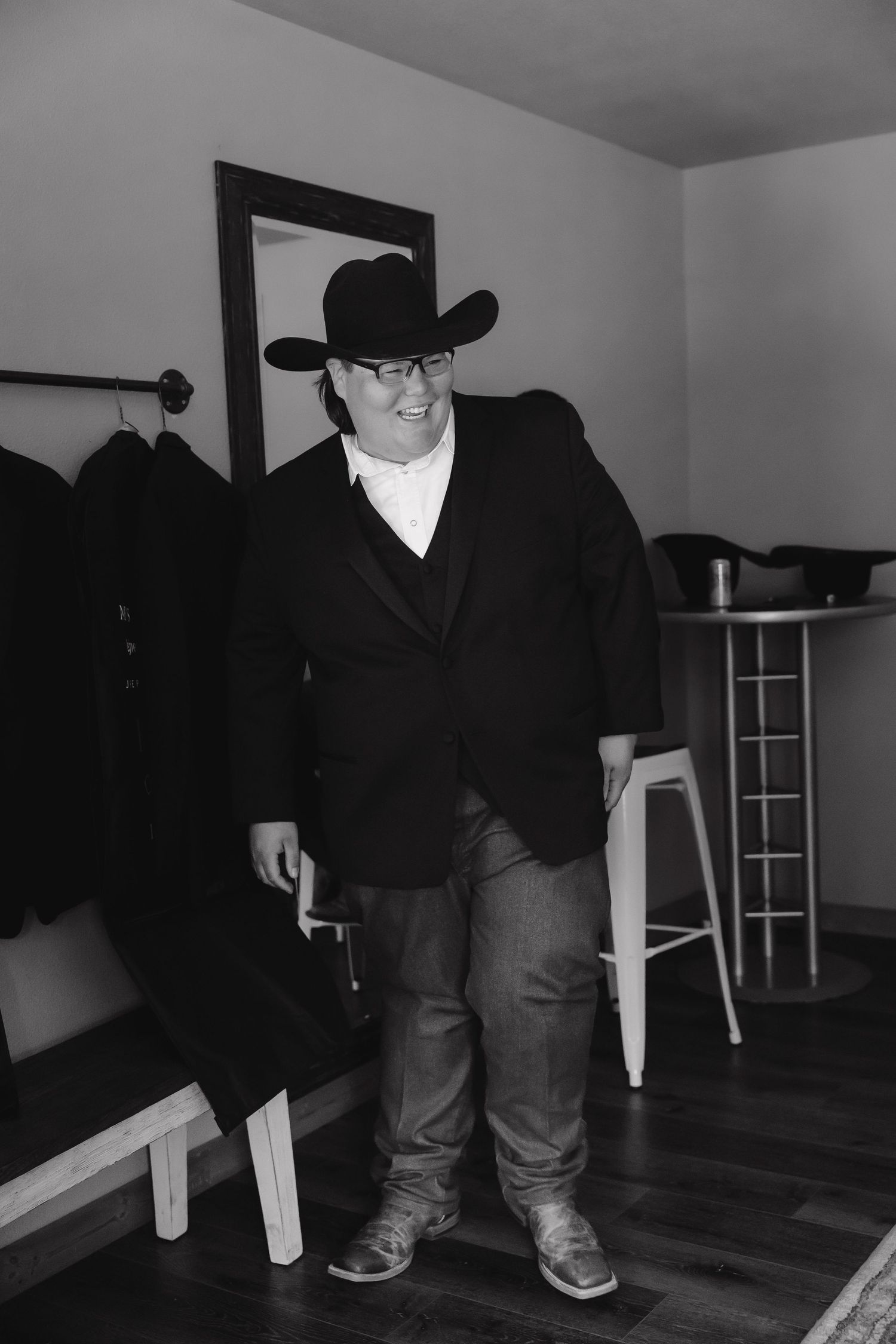 Low angle black and white shot showing boots and jeans in an indoor setting.
