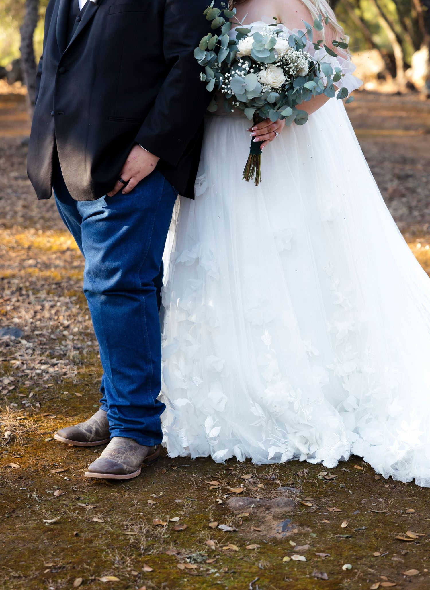 Western wedding photos with cowboy and his wife florals