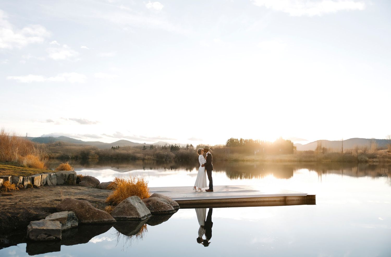 Montana couple eloping in the sunset surrounded by a lake