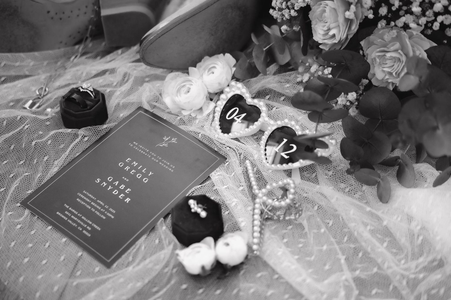 Elegant wedding stationery and floral arrangements in black and white with delicate lace details.