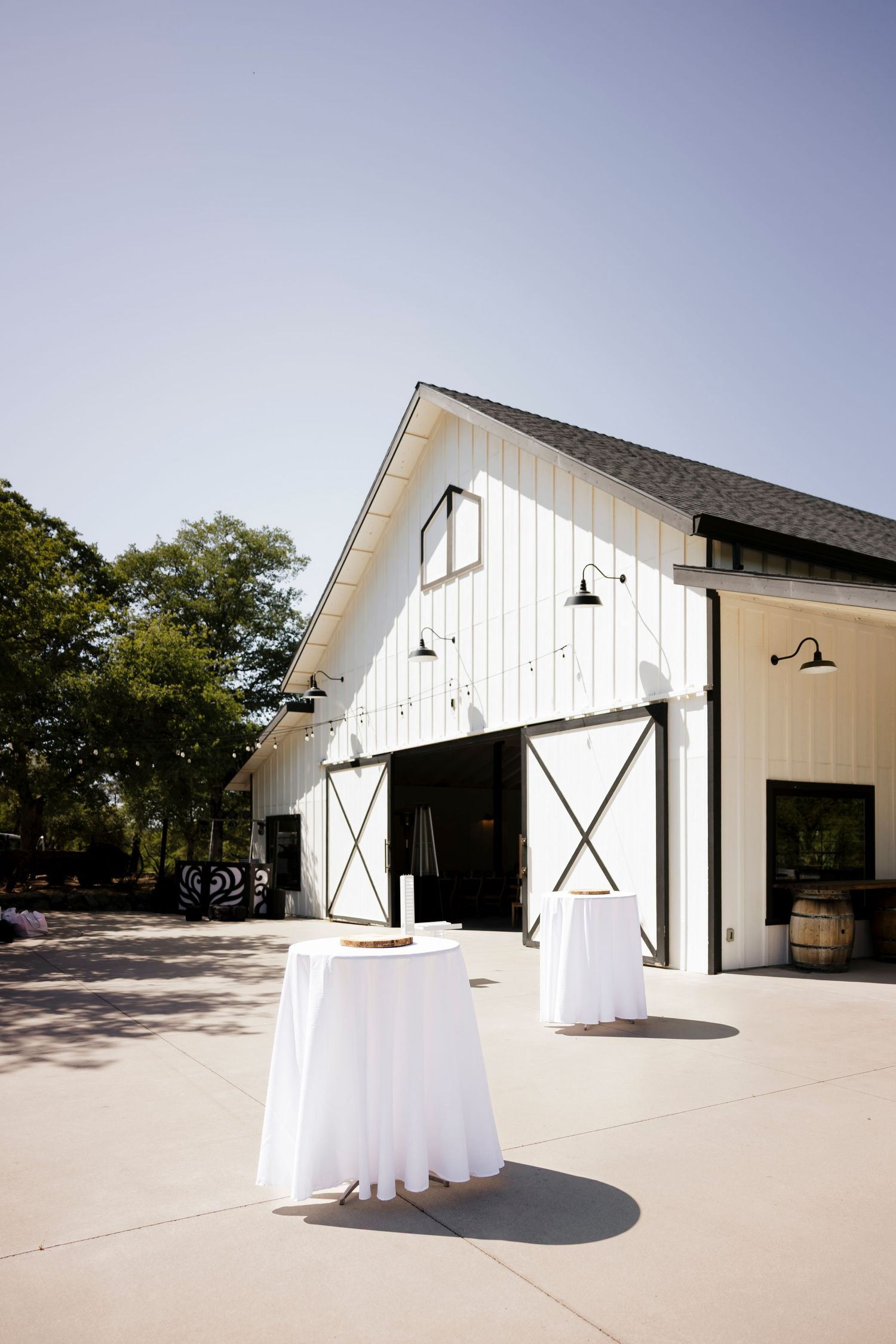 Modern white barn wedding venue exterior with black trim and minimalist design.