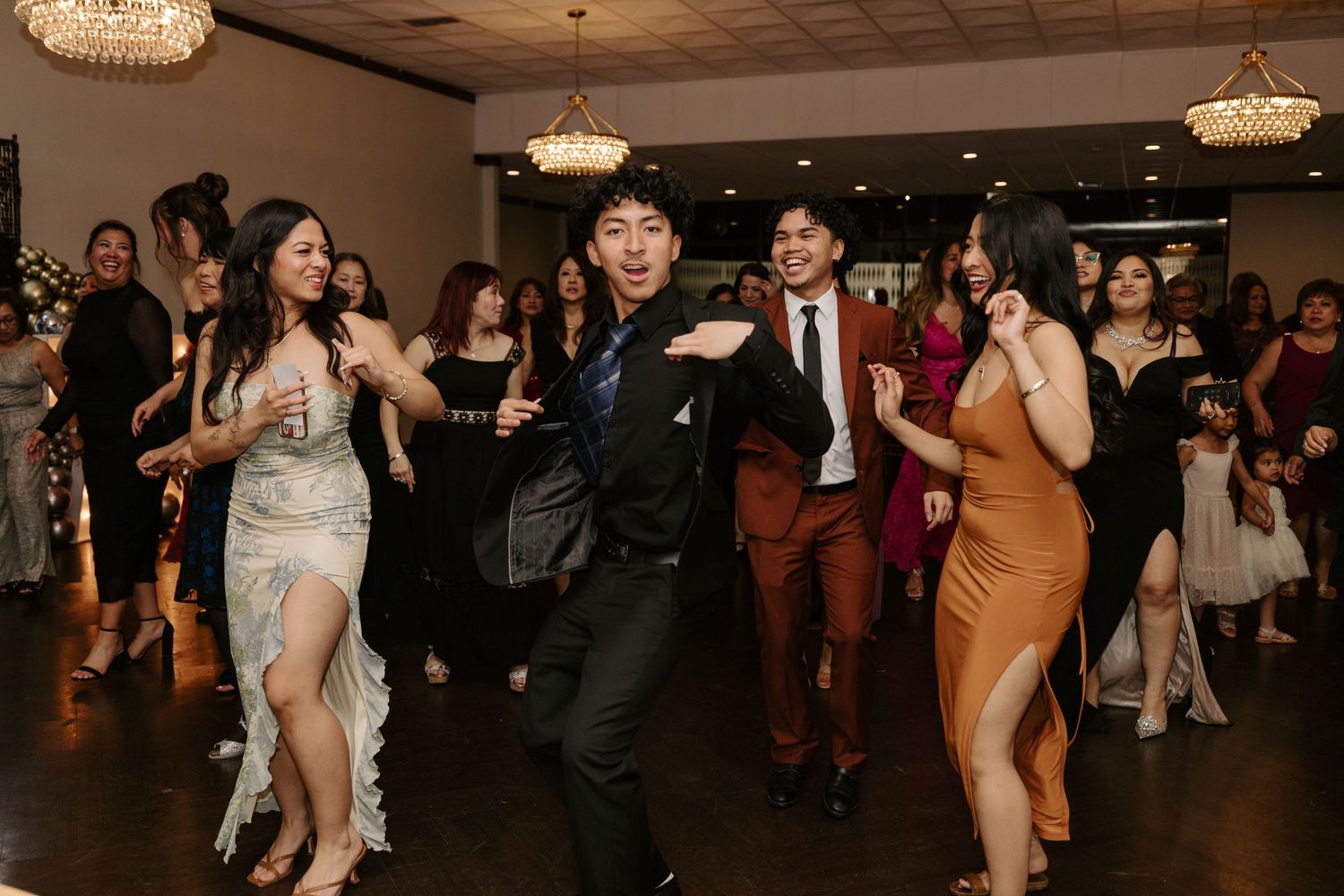 Guests enjoying themselves during a dance celebration in an elegantly lit venue.