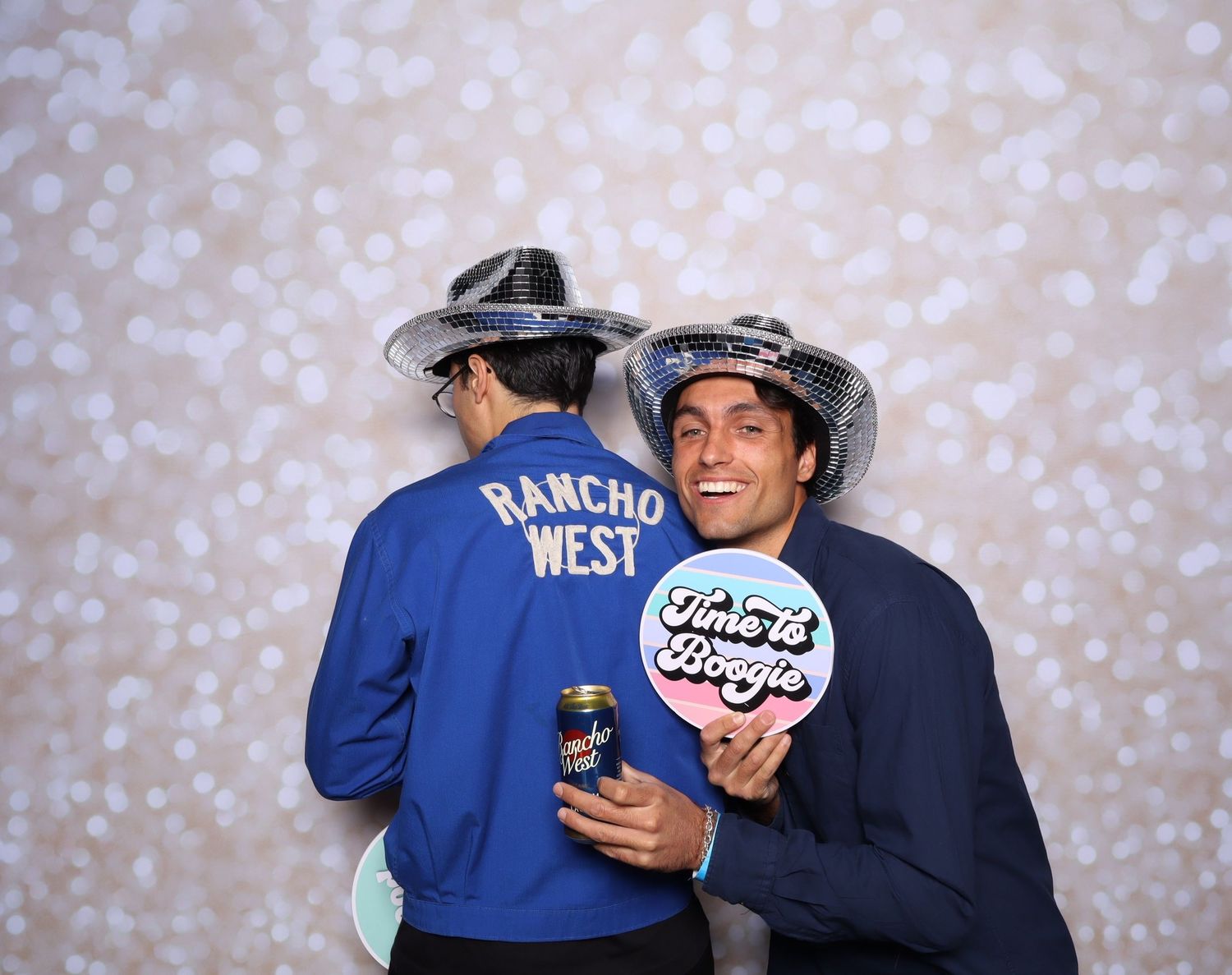 A sequence of five photos showing two people in blue jackets embracing and celebrating together against a sparkly backdrop.