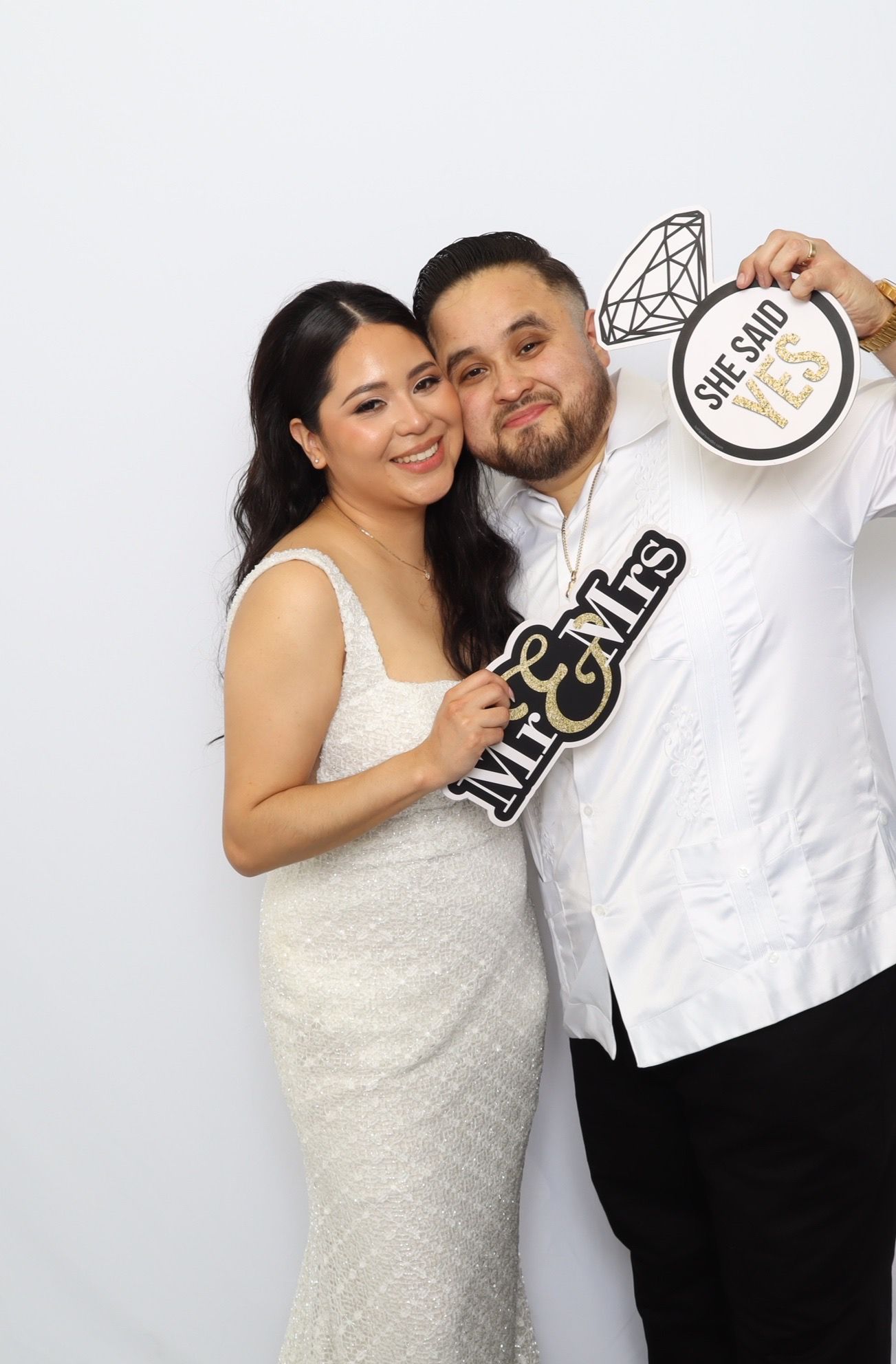 A couple poses together in a wedding photo booth sequence showing playful and romantic moments.