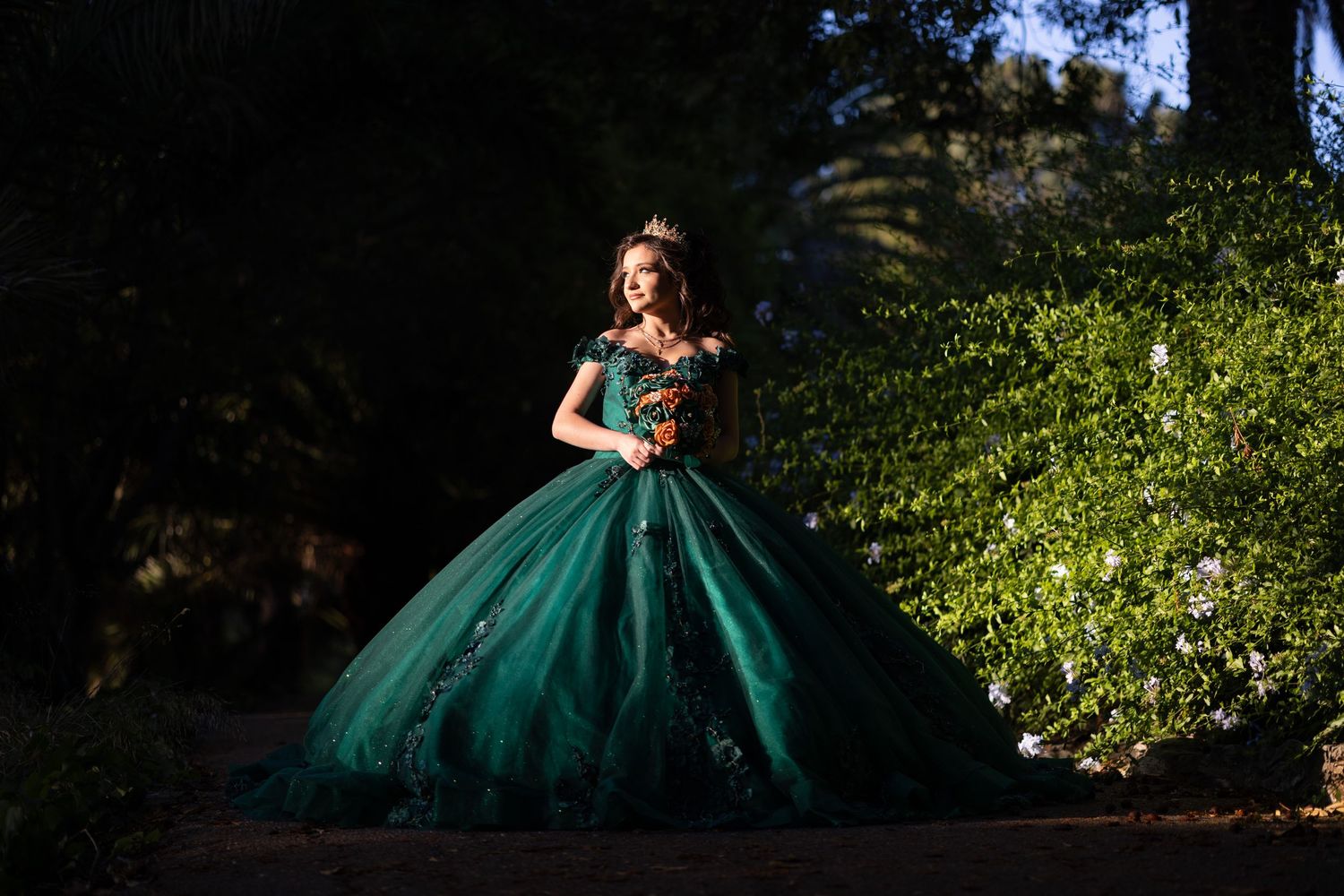 Emerald green quinceañera dress captured in multiple angles against lush garden scenery.