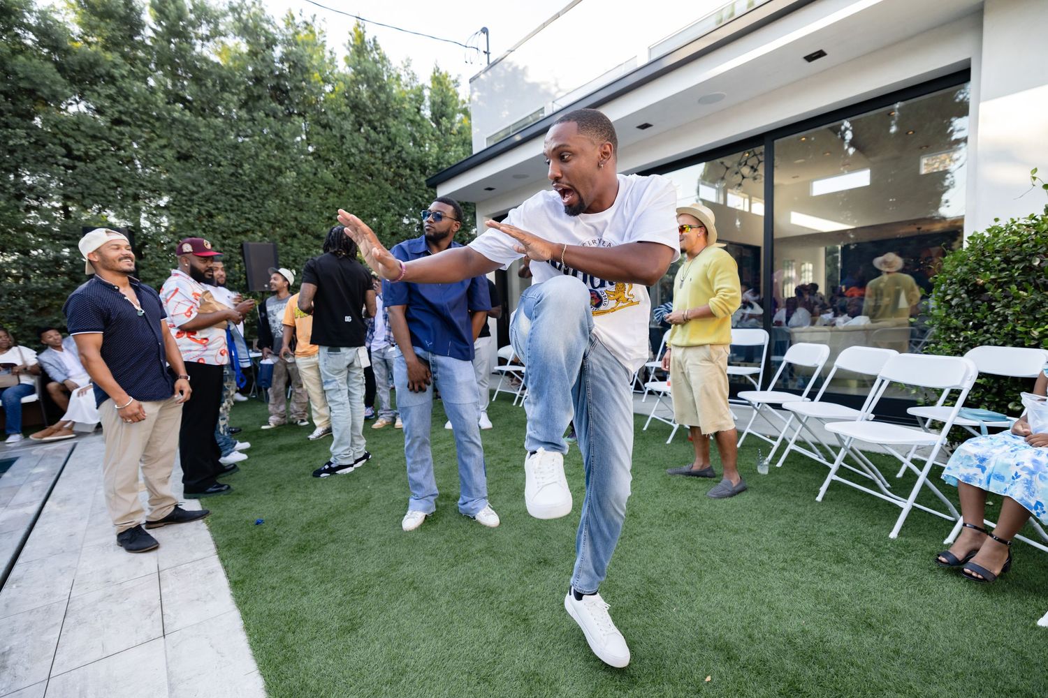 A guest dancing enthusiastically on artificial grass at an outdoor event.