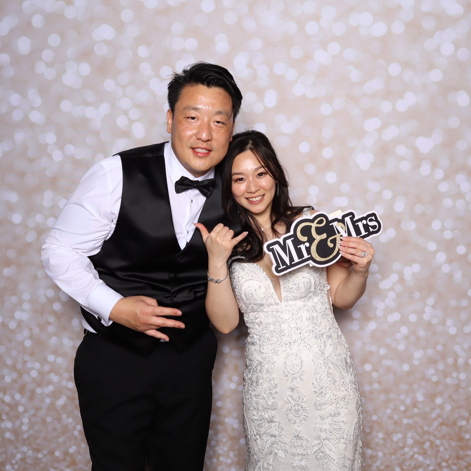 Couple in formal attire poses playfully in sequence of photo booth style shots against a sparkly backdrop.