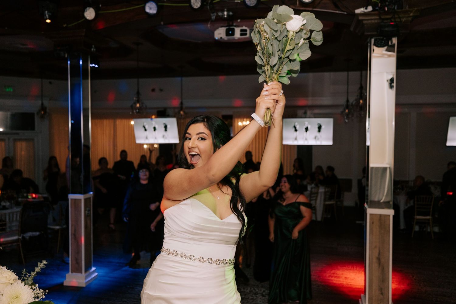 A celebratory moment as money is tossed in the air at a wedding reception.