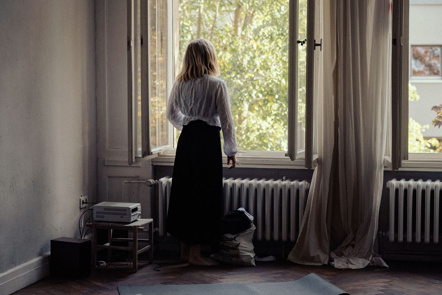 Woman watching out of a window at a Yoga Festival in Berlin