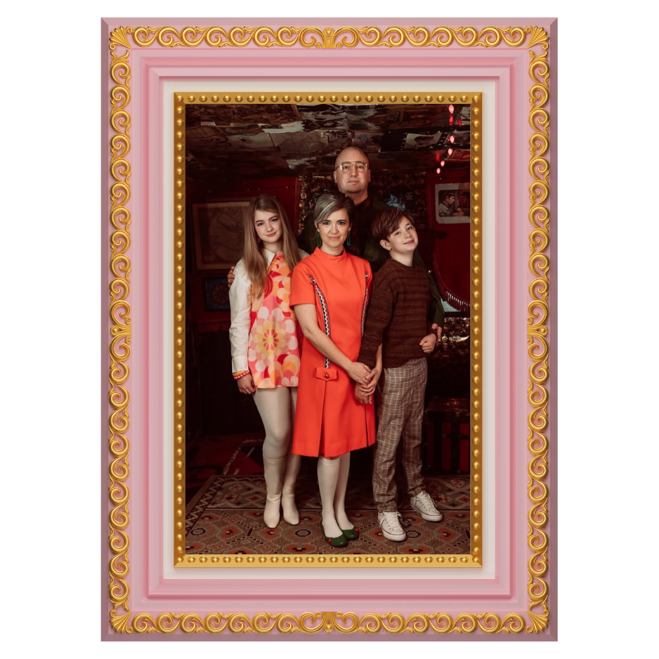 Family of four posing together in pink and gold ornate decorative picture frame portrait.