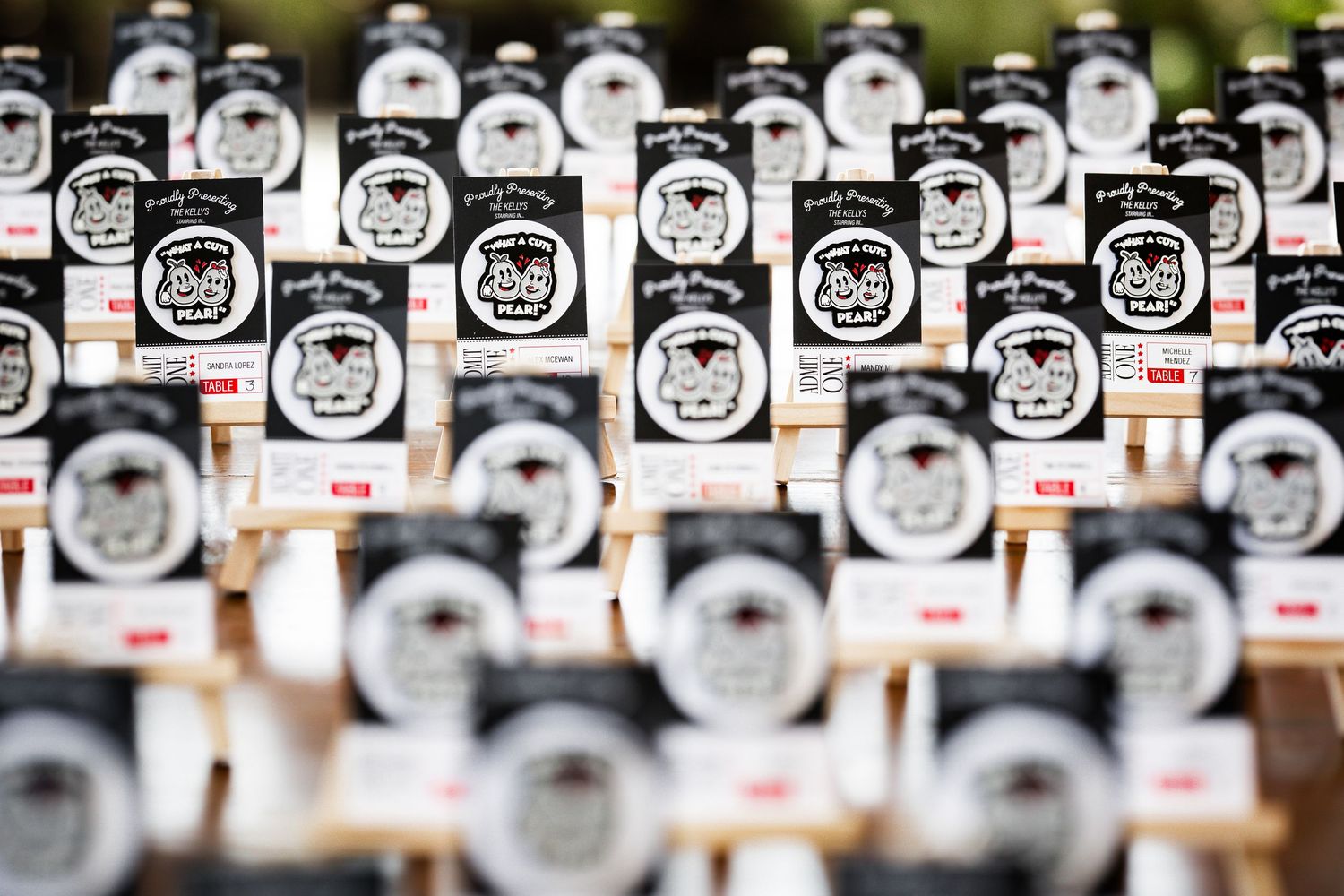 Rows of artisan jam jars with decorative black and white skull labels displayed on wooden shelves at a market.