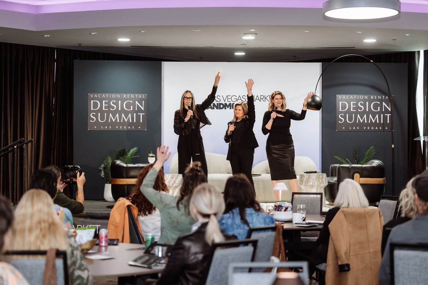 Four women presenting on stage at the Vacation Rental Design Summit in Las Vegas.