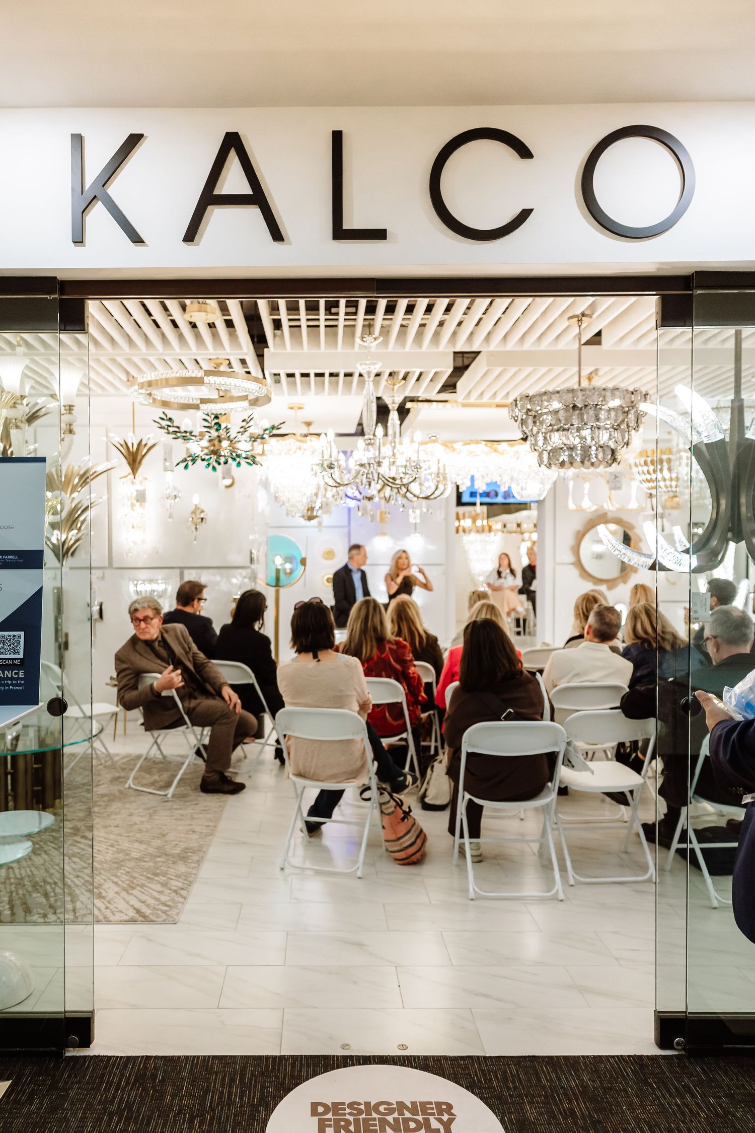Attendees gather inside a Kalco lighting showroom for a designer-friendly presentation event.