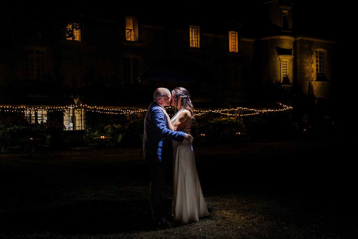 Wedding couple share a kiss at Chateau Mas de Montet Dordogne France
