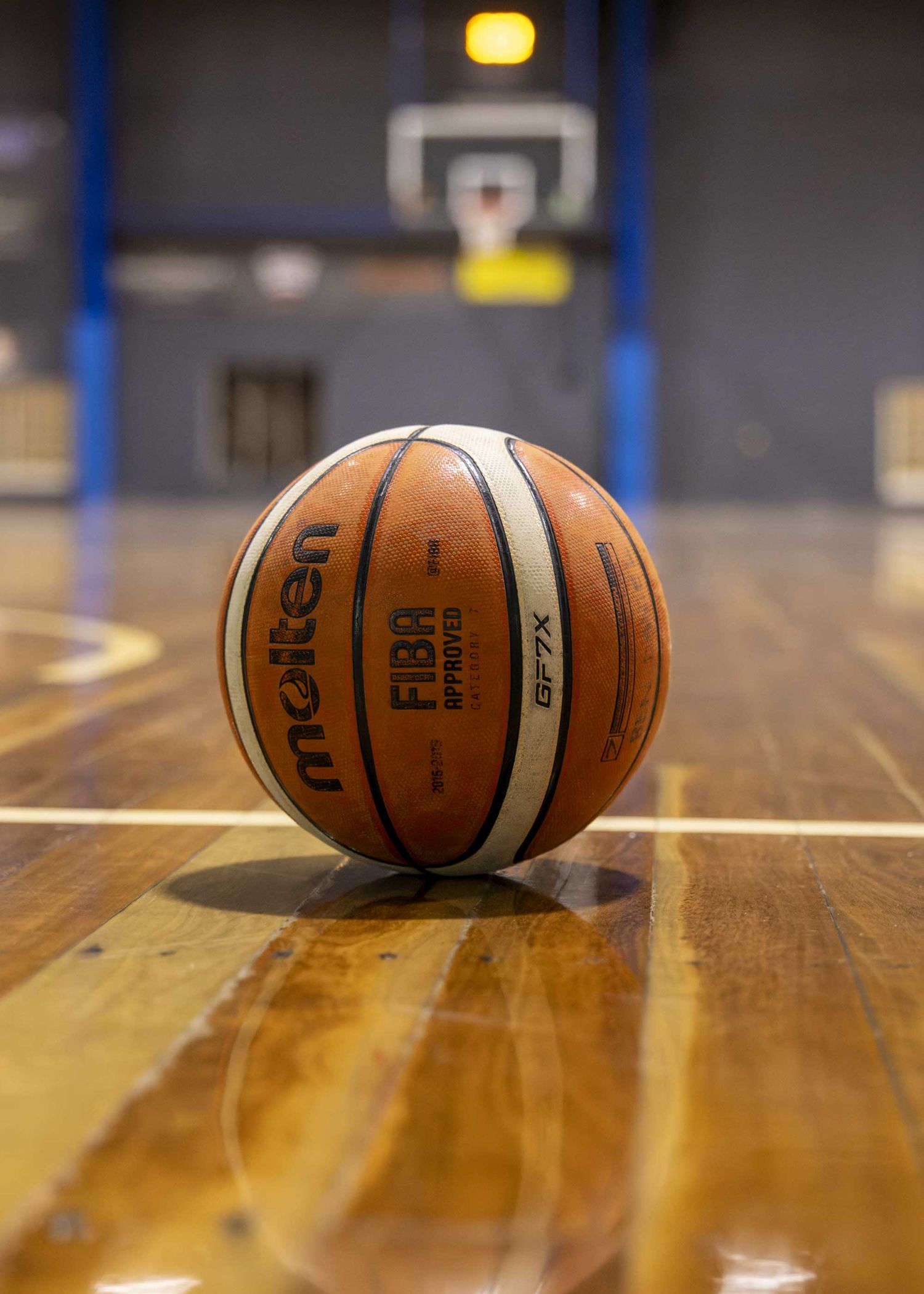 Molten basketball sitting on court floor on side during half time. Image by Nick Wigmore Photography
