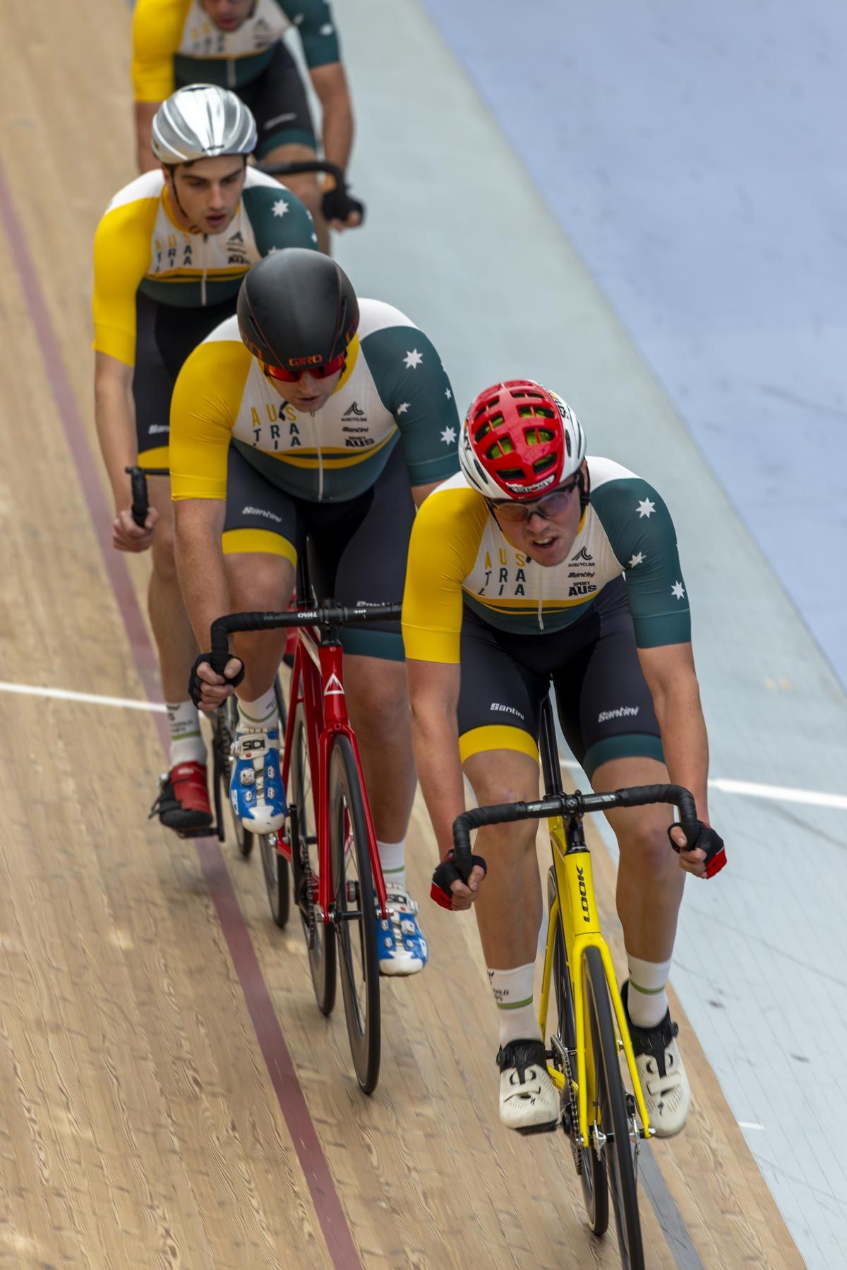 Group of indoor Australian Paralympic cyclists racing in velodrome. Image by Nick Wigmore Photography
