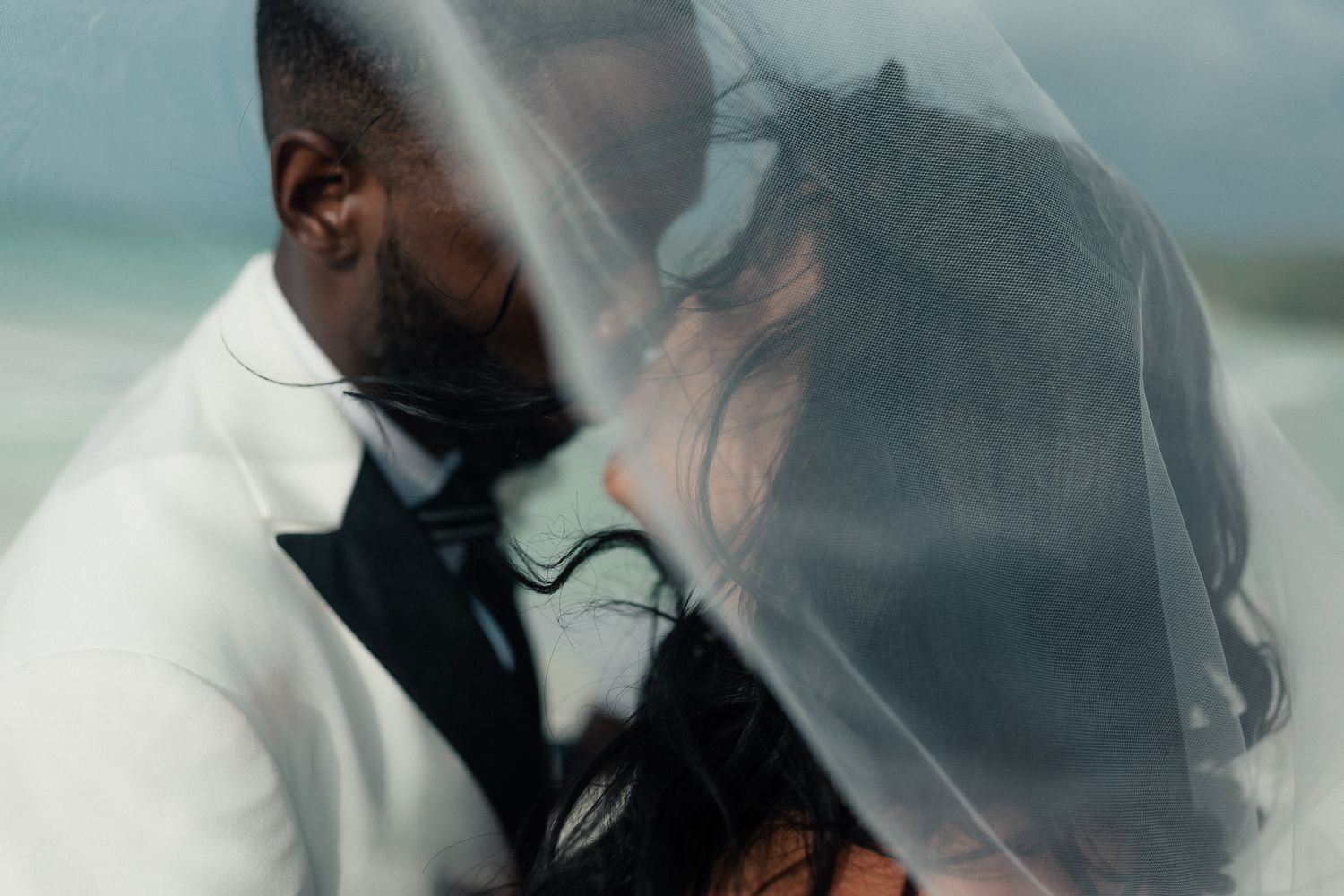 Smoke billows and swirls around a person in a white jacket creating an artistic ethereal atmosphere.