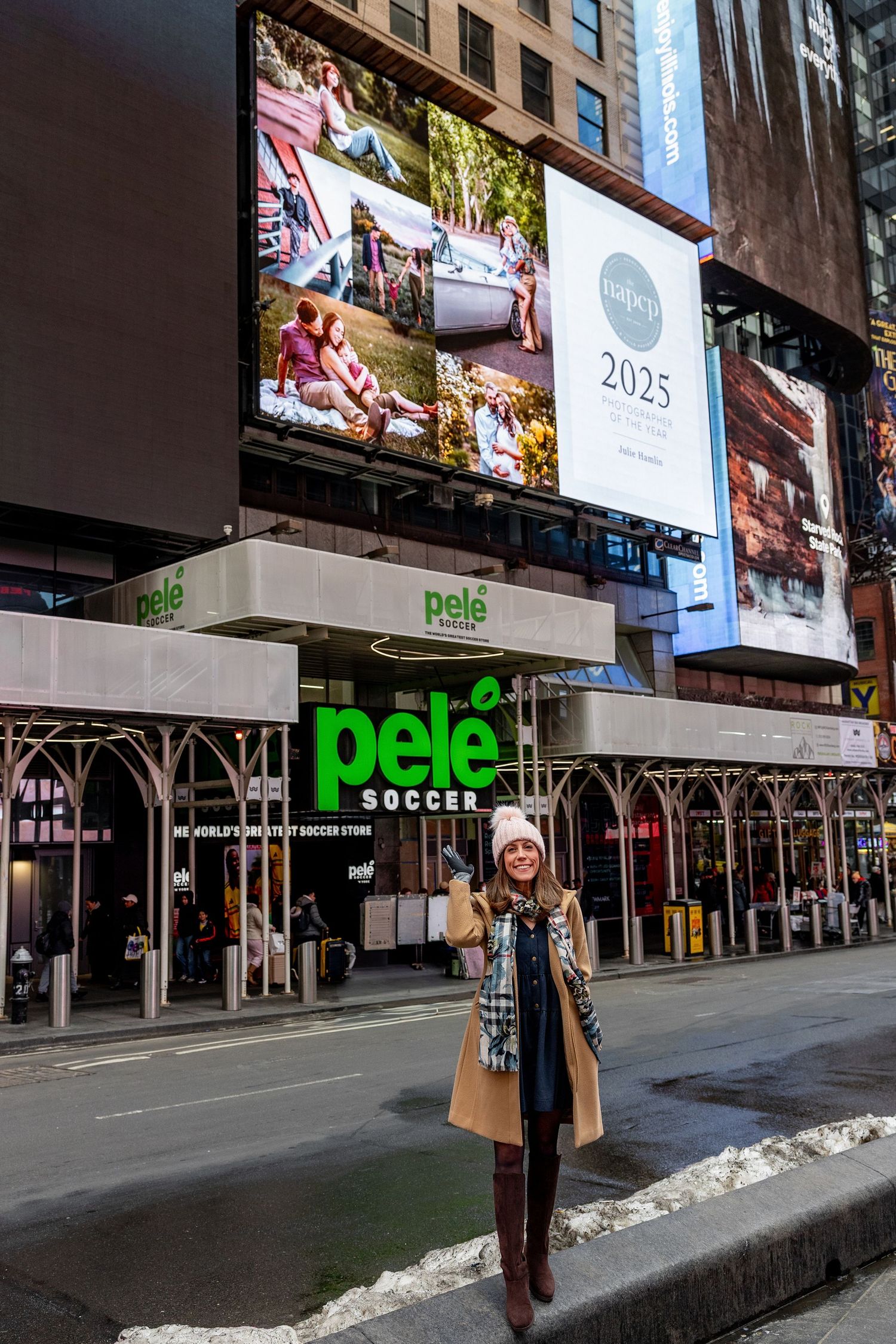Person posing on a city street in winter attire in front of a Pele Soccer store with billboard displays above.