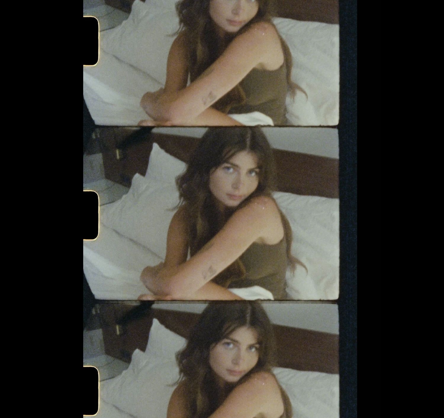 Three vintage film strip frames showing someone posing on white bedding in a casual portrait style.