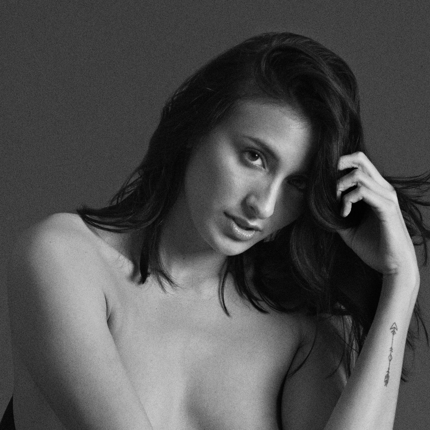 Black and white artistic portrait series showing intimate expressions and poses in dramatic lighting.