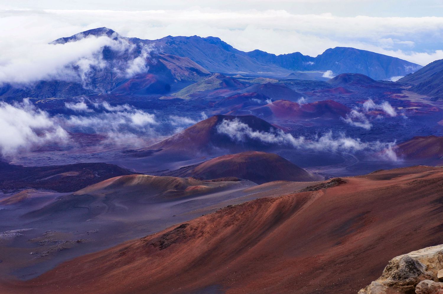 A deeply colored view of the inner rim of a dormant volcano in Hawaii.