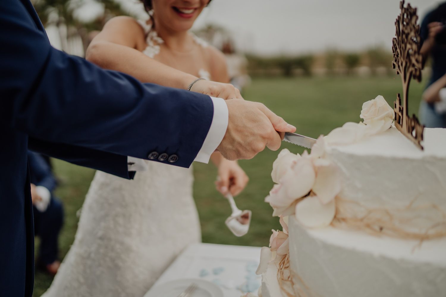 Algarve wedding photographer capturing an emotional cake cutting scene at beachside venue