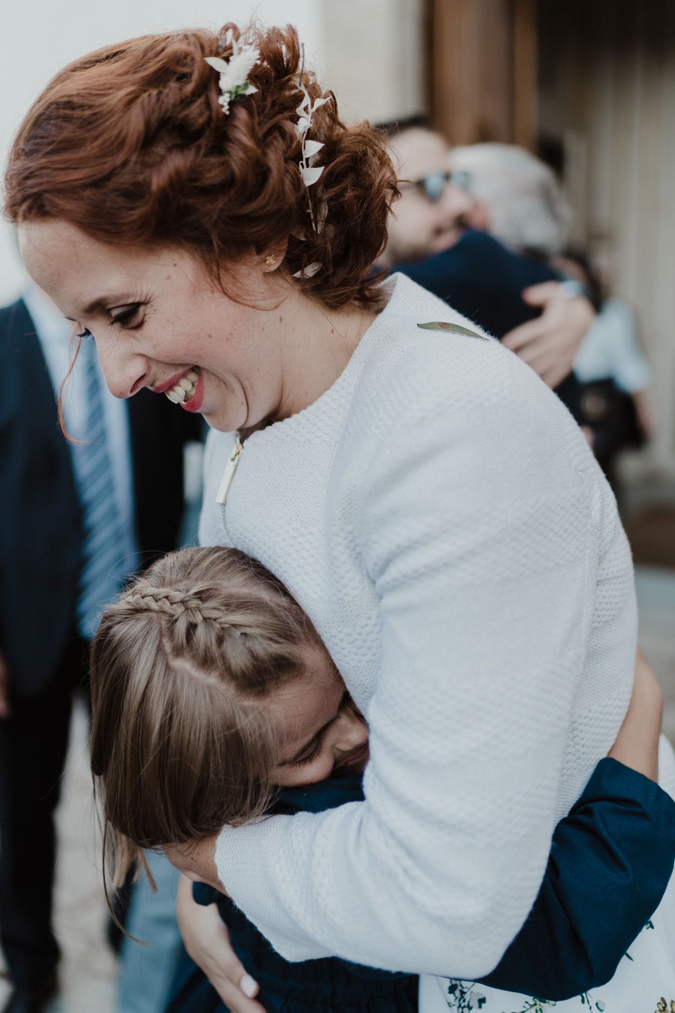 Mother holding her child during an intimate wedding day in Porto