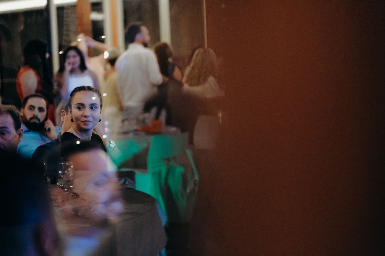 Bride and groom sharing their first dance under string lights at Algarve wedding