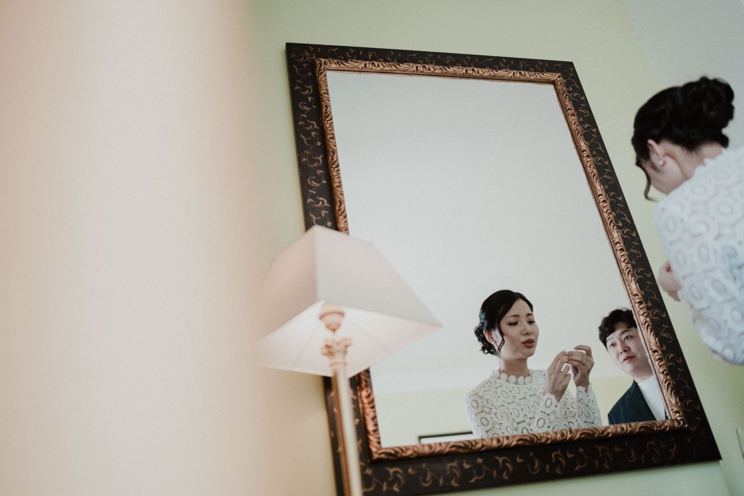 Couple reflected in a large mirror while getting ready, elopement in Porto, Portugal
