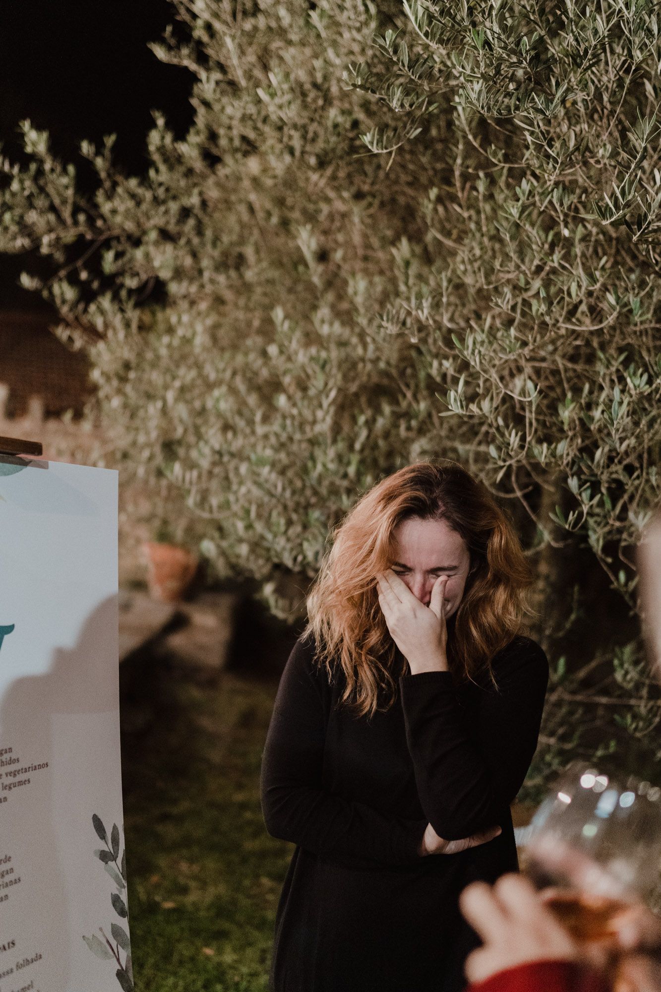 Wedding guest laughing during a relaxed celebration in Porto