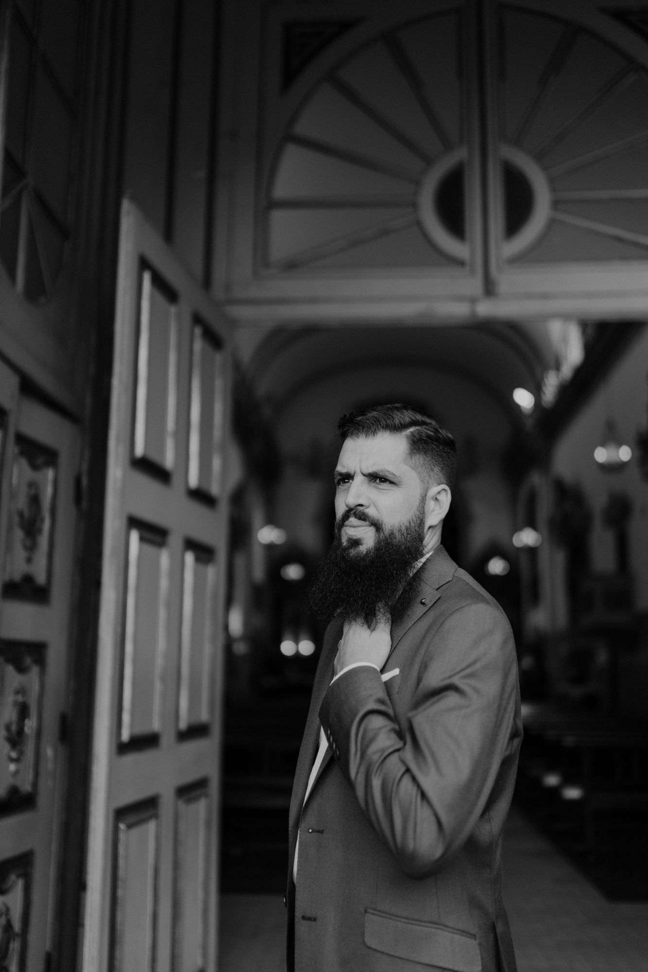 Wedding guest standing at a church entrance in Porto