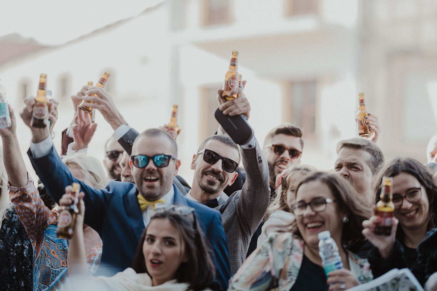 Group of wedding guests celebrating together in Porto, with a superbock beer