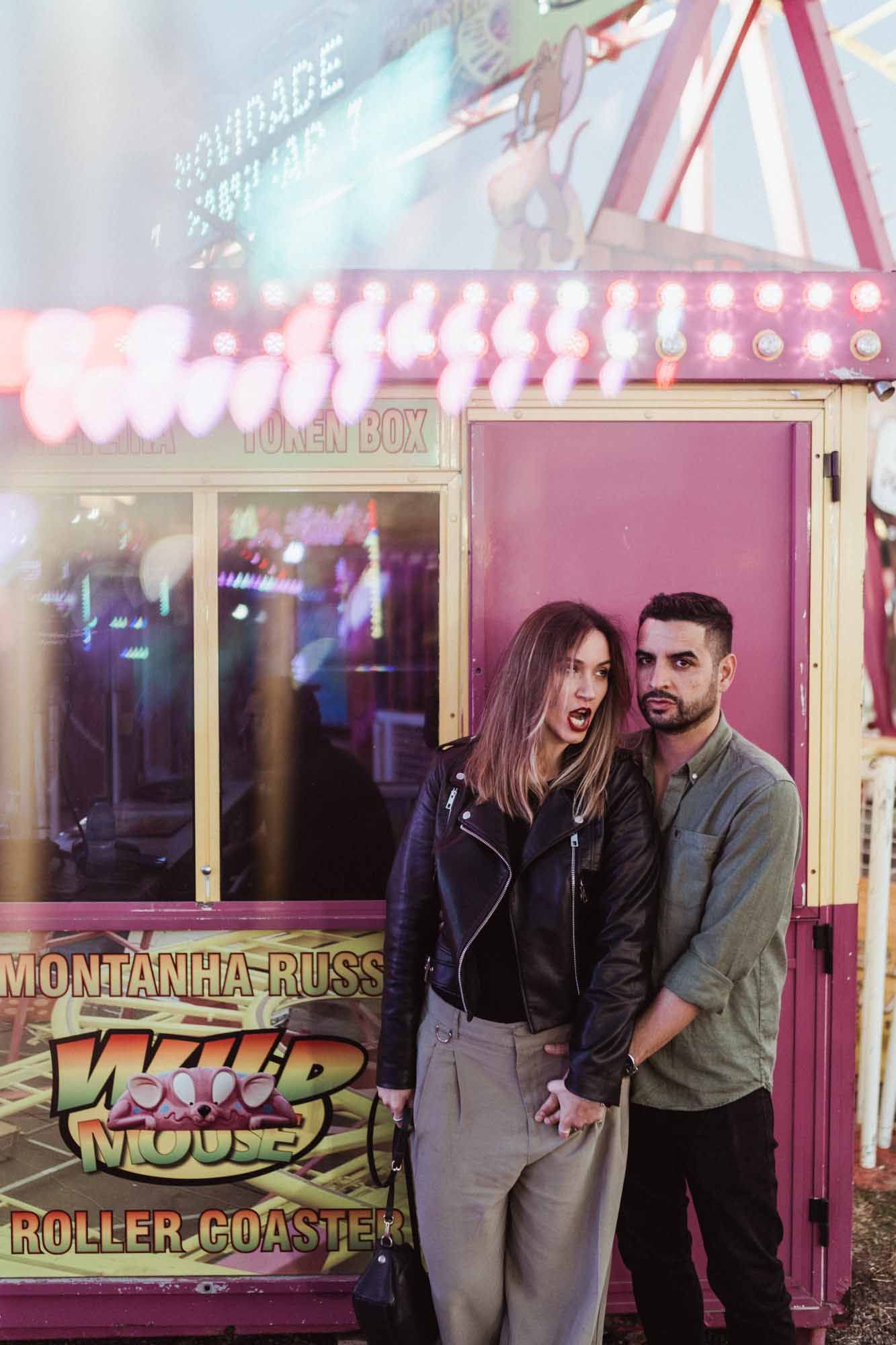 Fairground lights and bold love — cinematic couple photography in Portugal